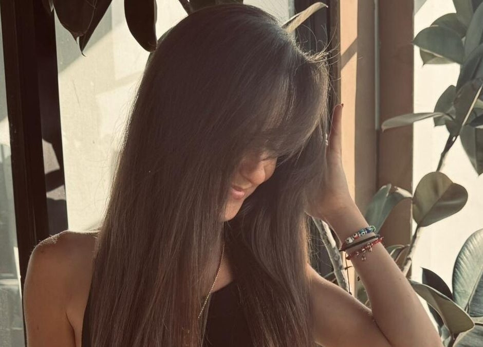 Customer enjoying stylish long hair at Planet Stella hair salon in North Miami Beach, Florida, US.