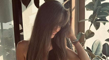 Customer enjoying stylish long hair at Planet Stella hair salon in North Miami Beach, Florida, US.