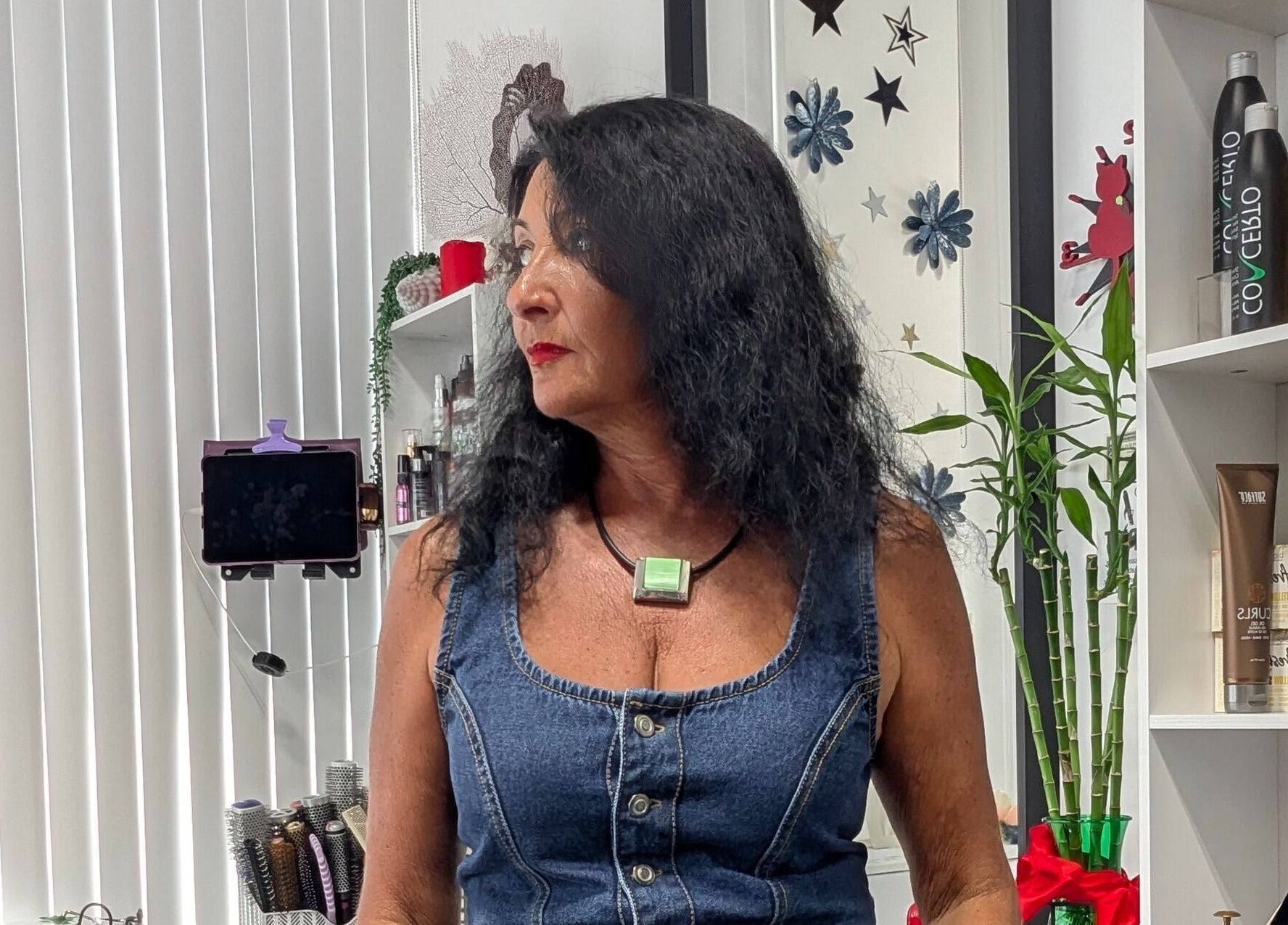 Stylish woman at Planet Stella hair salon in North Miami Beach, Florida, US, showcasing modern decor and products.