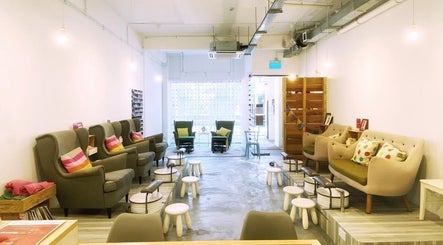 Warm, inviting interior of Paint Shoppe Nail Spa in Singapore, Singapore, SG with plush seating and bright decor.