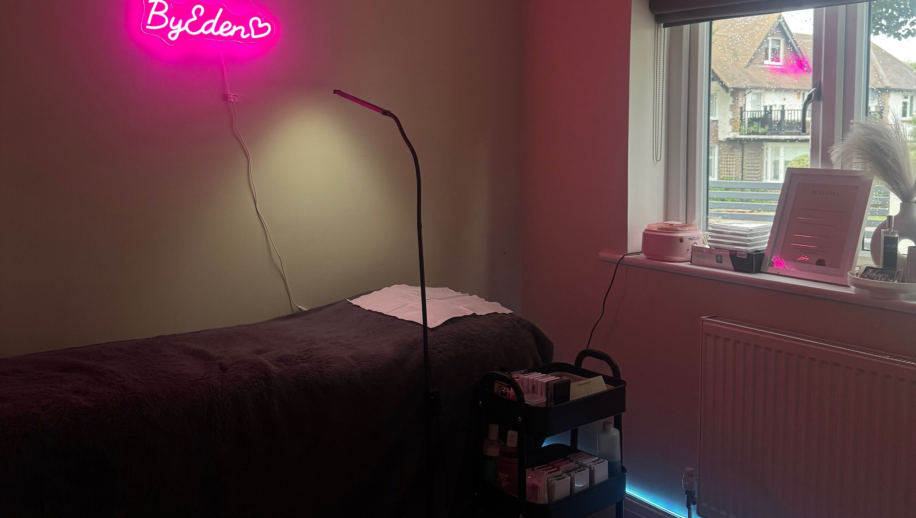 Cozy treatment room at Lashes by Eden, Brighton And Hove, England, featuring a plush bed and modern decor.