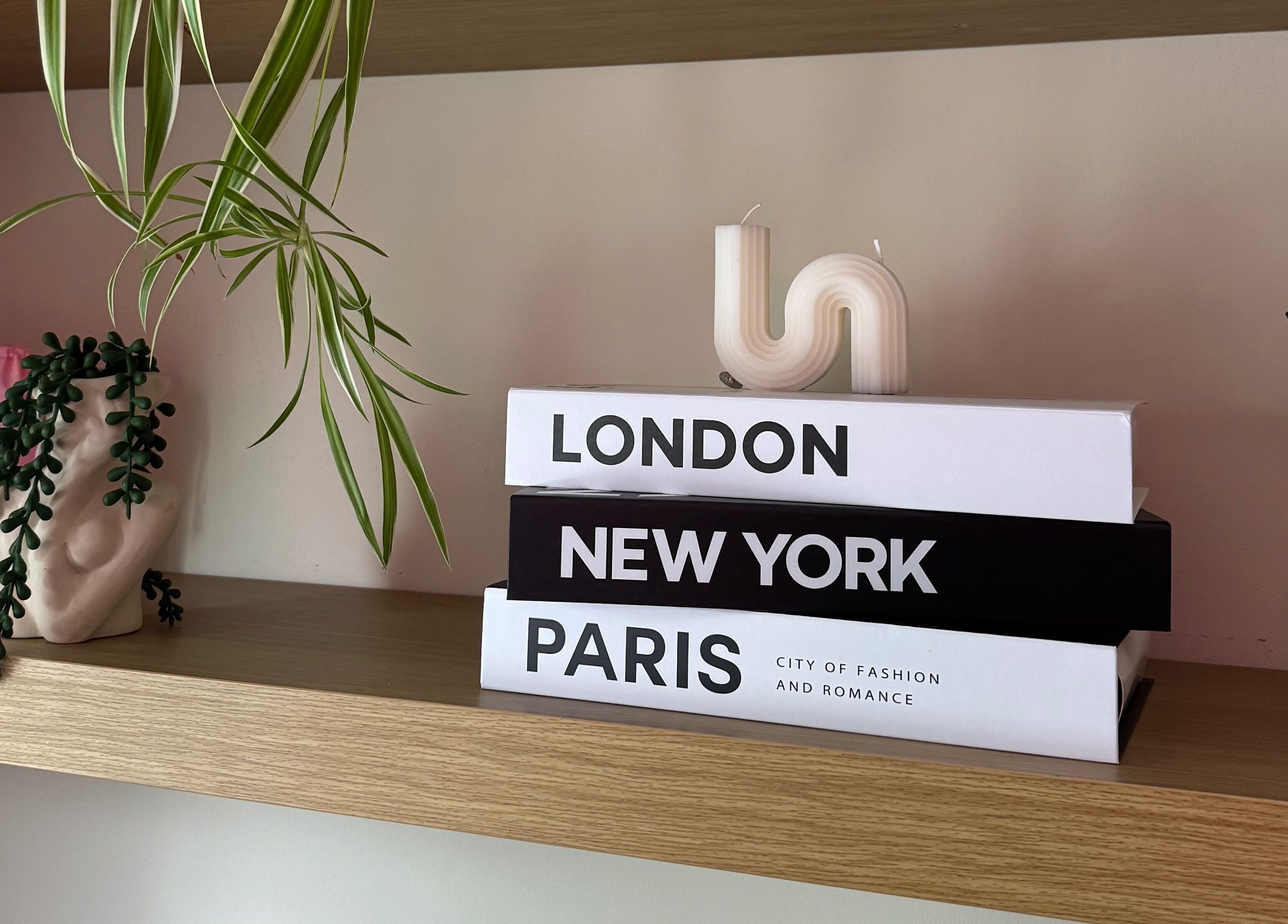 Styled wooden shelf at Lashes by Eden, Brighton And Hove, England, GB, with books, plant, and candle.