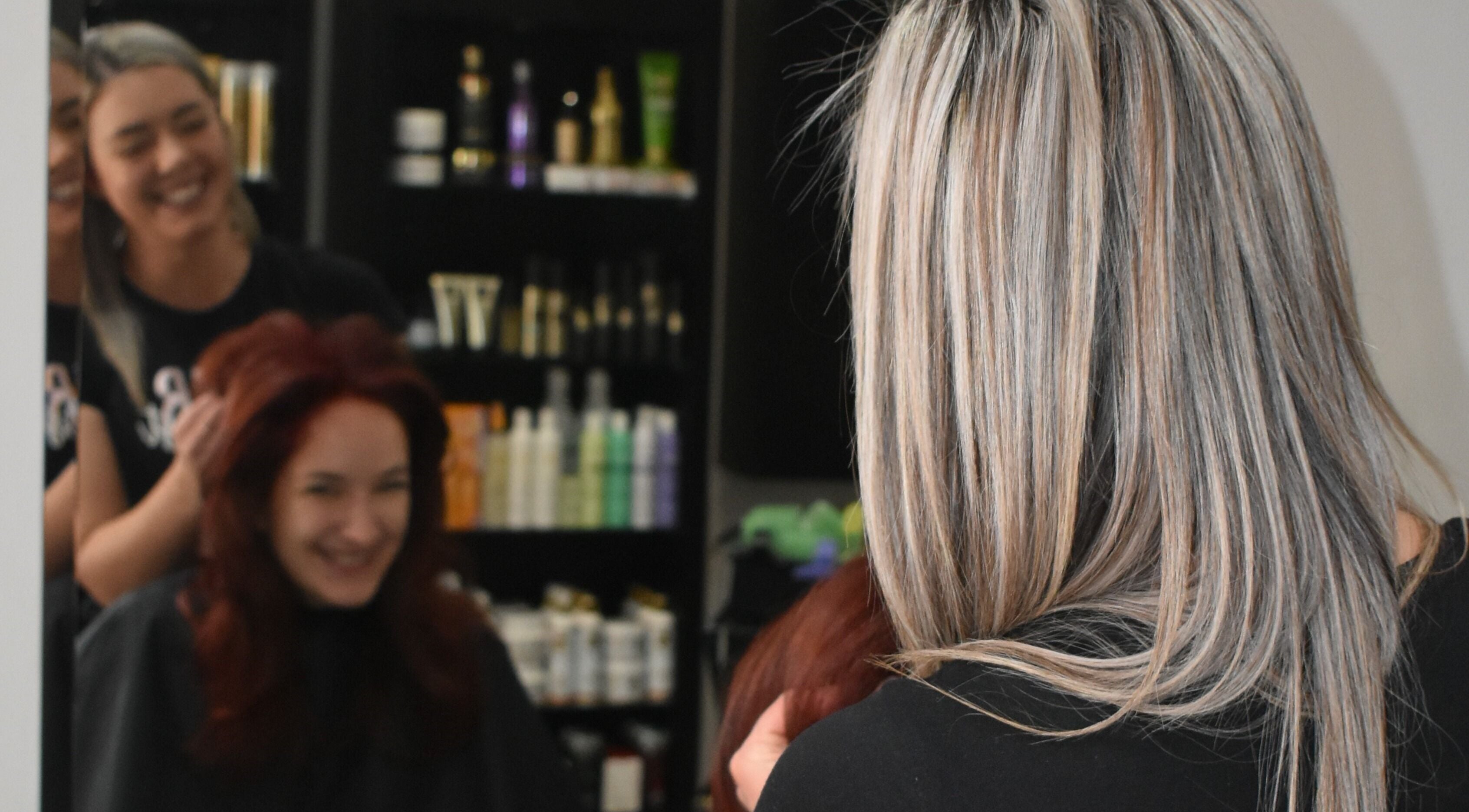 Hair stylist at Rejuven8 on Dexter Salon in Cape Town, Western Cape, ZA, creating a vibrant hairstyle.