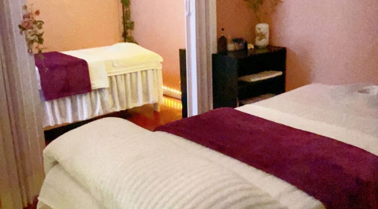 Relaxing massage room at Superior Health Massage, Lawrenceville, Georgia, US, with cozy beds and soft lighting.