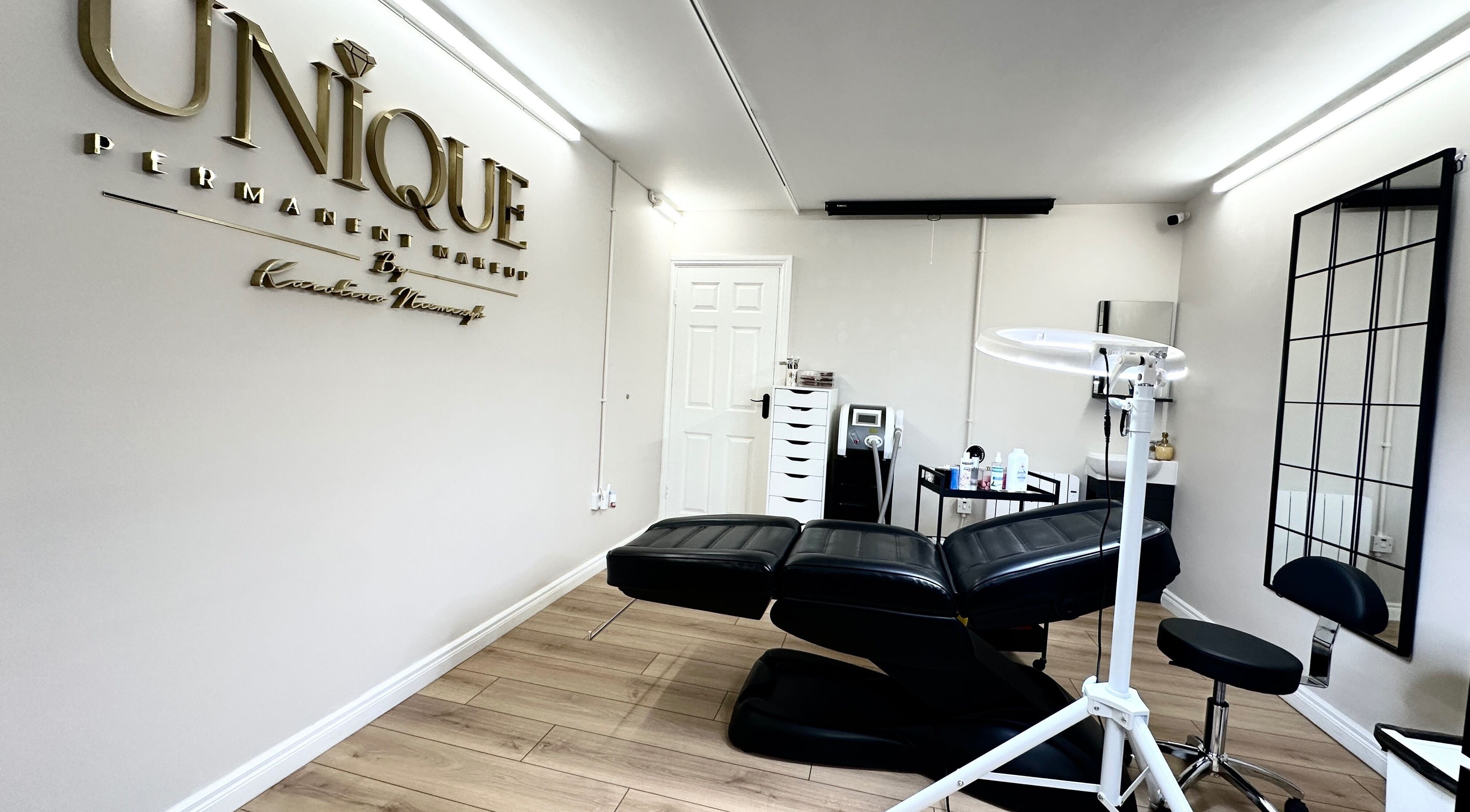 Modern treatment room at Unique Permanent Makeup in Tralee, County Kerry, IE featuring comfortable seating.