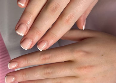 Neatly polished nails with French tips at The BIAB Room, Cwmparc, Wales, GB.