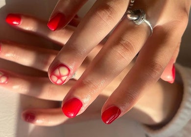 Stylish red nail art at The BIAB Room, Cwmparc, Wales, GB, showcasing elegant manicure with unique patterns.