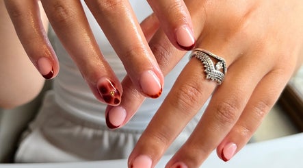 Elegant nail art with red accents at The Biab Room, Cwmparc, Wales, GB.