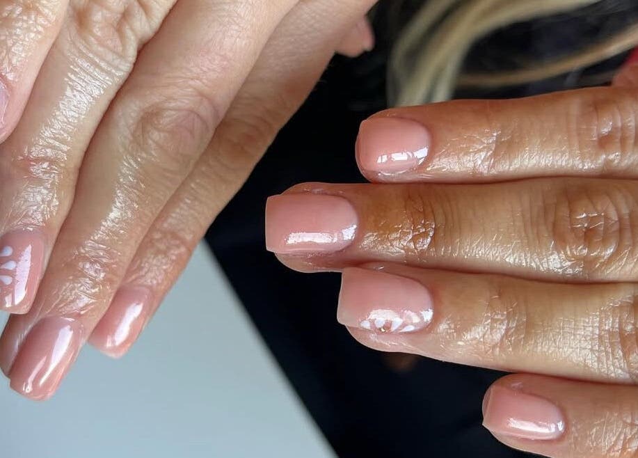 Elegant nude nail art with floral design at The Biab Room, Cwmparc, Wales, GB.