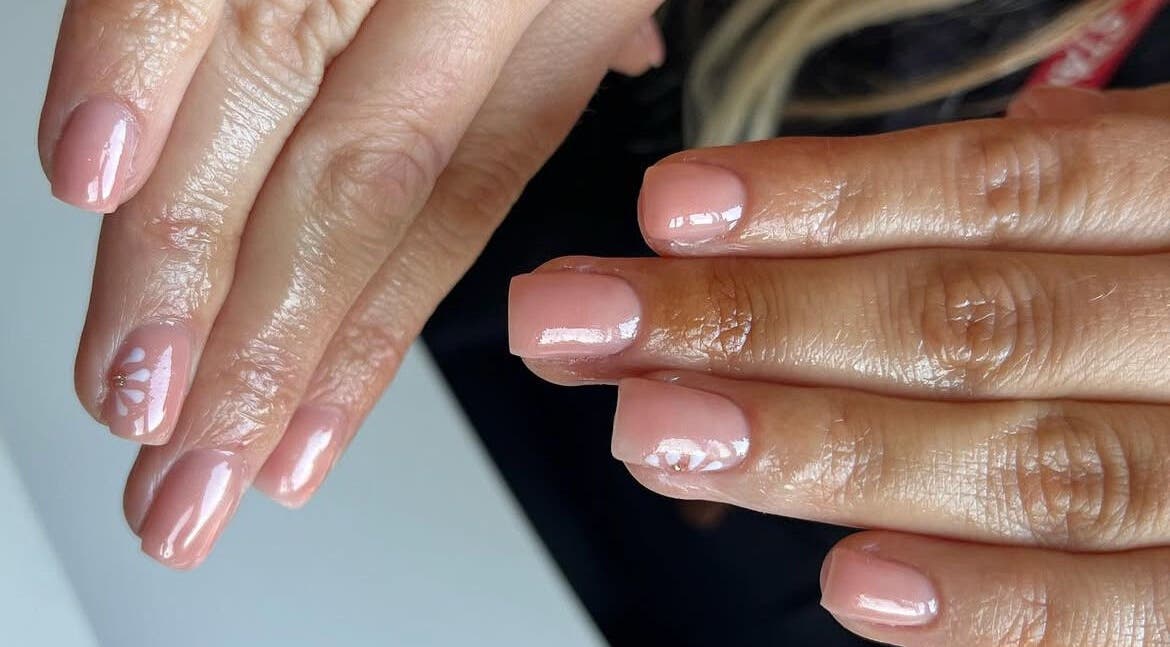 Elegant nude nail art with floral design at The Biab Room, Cwmparc, Wales, GB.