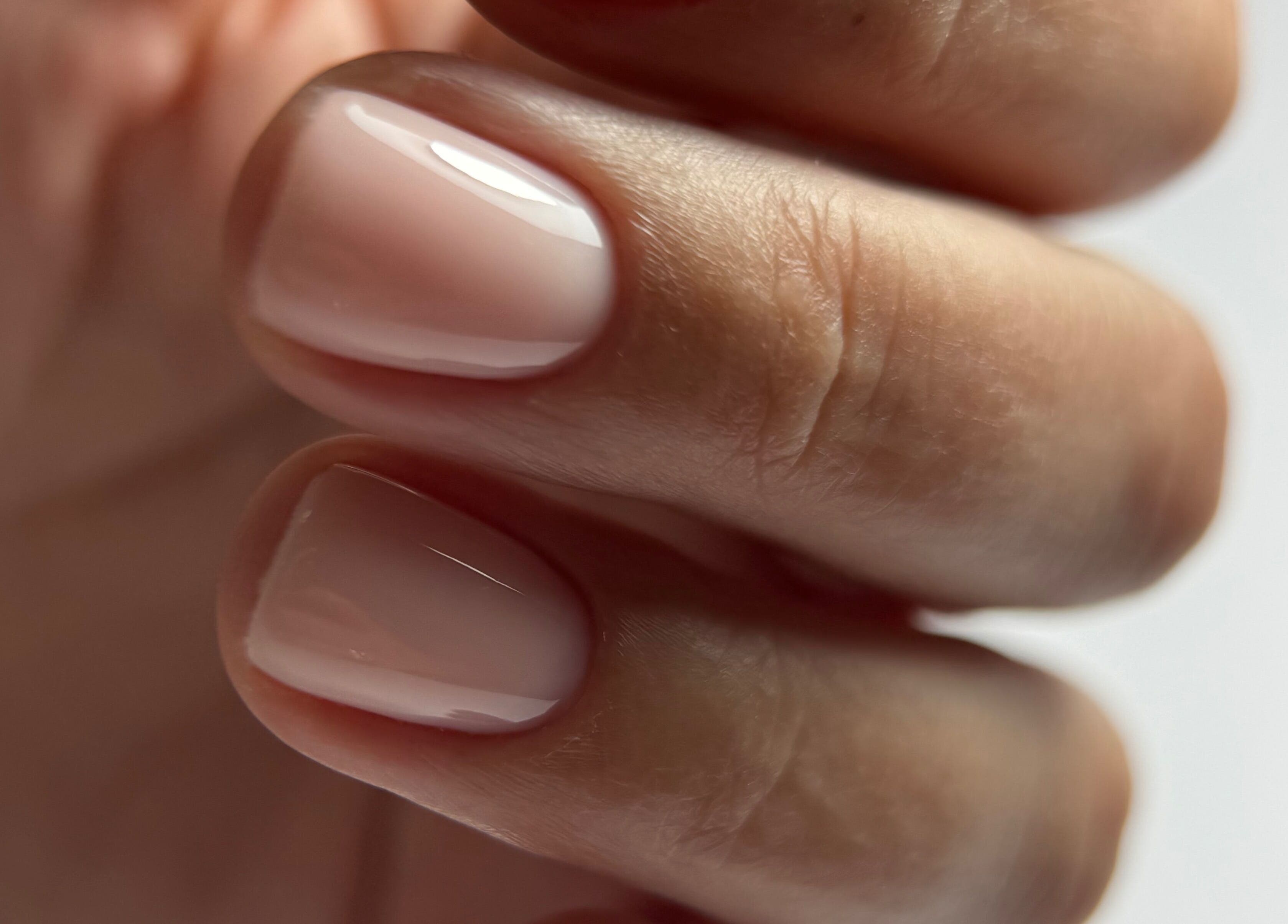 Close-up of manicured nails at Zhekova Nails Academy, Epsom, England, GB, showcasing smooth glossy finish.