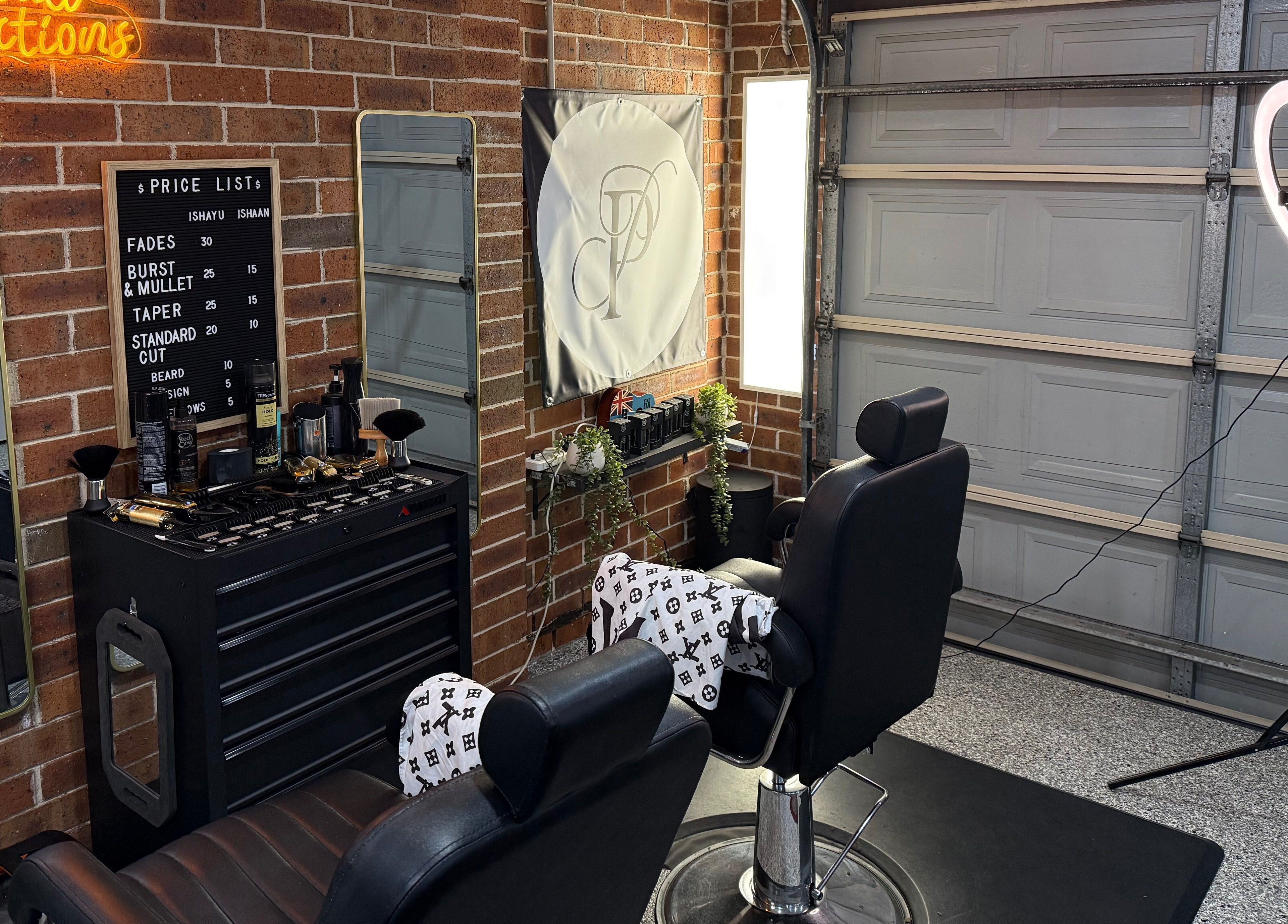 Modern salon interior at Prasad Productions, Prestons, New South Wales, AU showcasing barber chairs and mirrors.