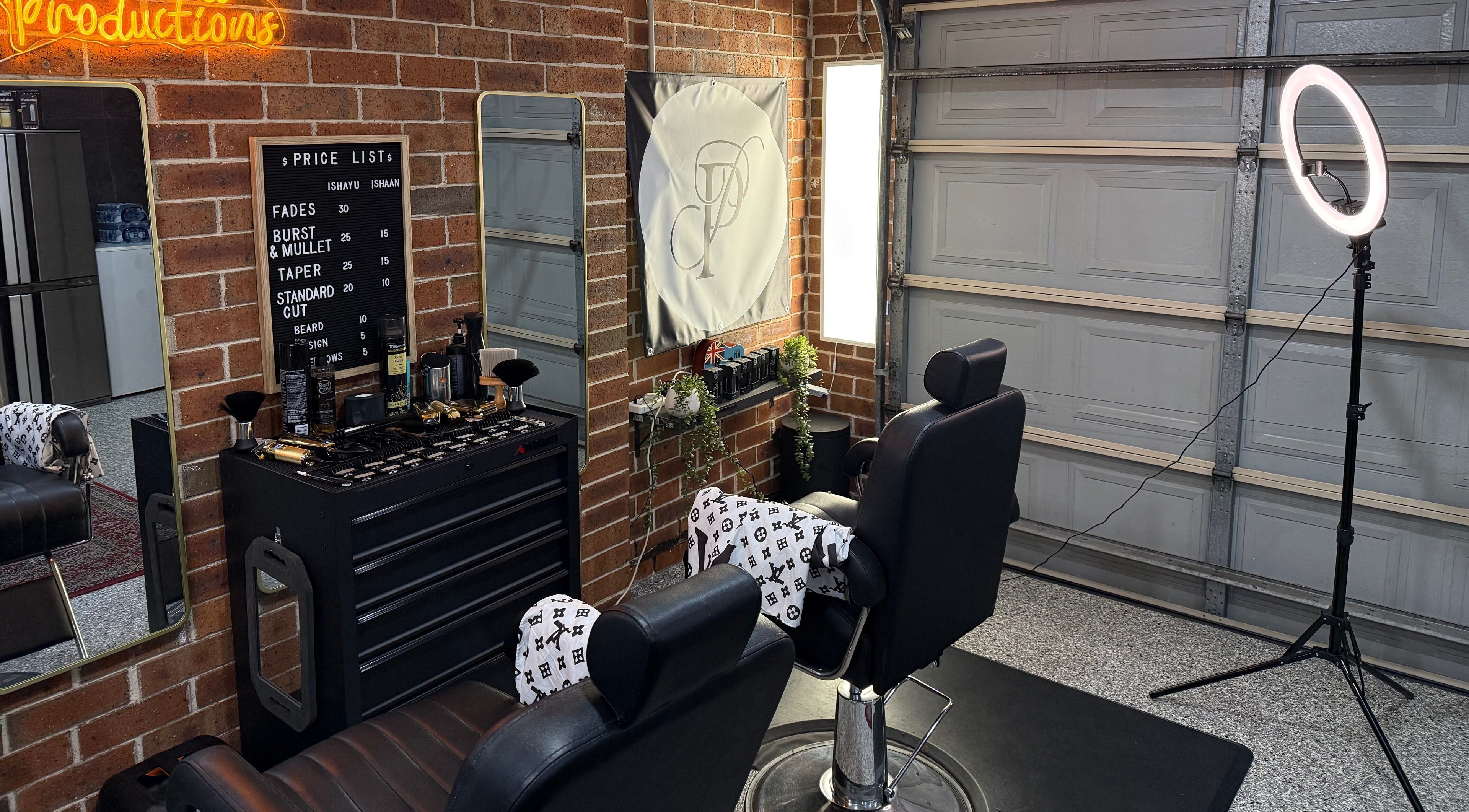 Modern salon interior at Prasad Productions, Prestons, New South Wales, AU showcasing barber chairs and mirrors.