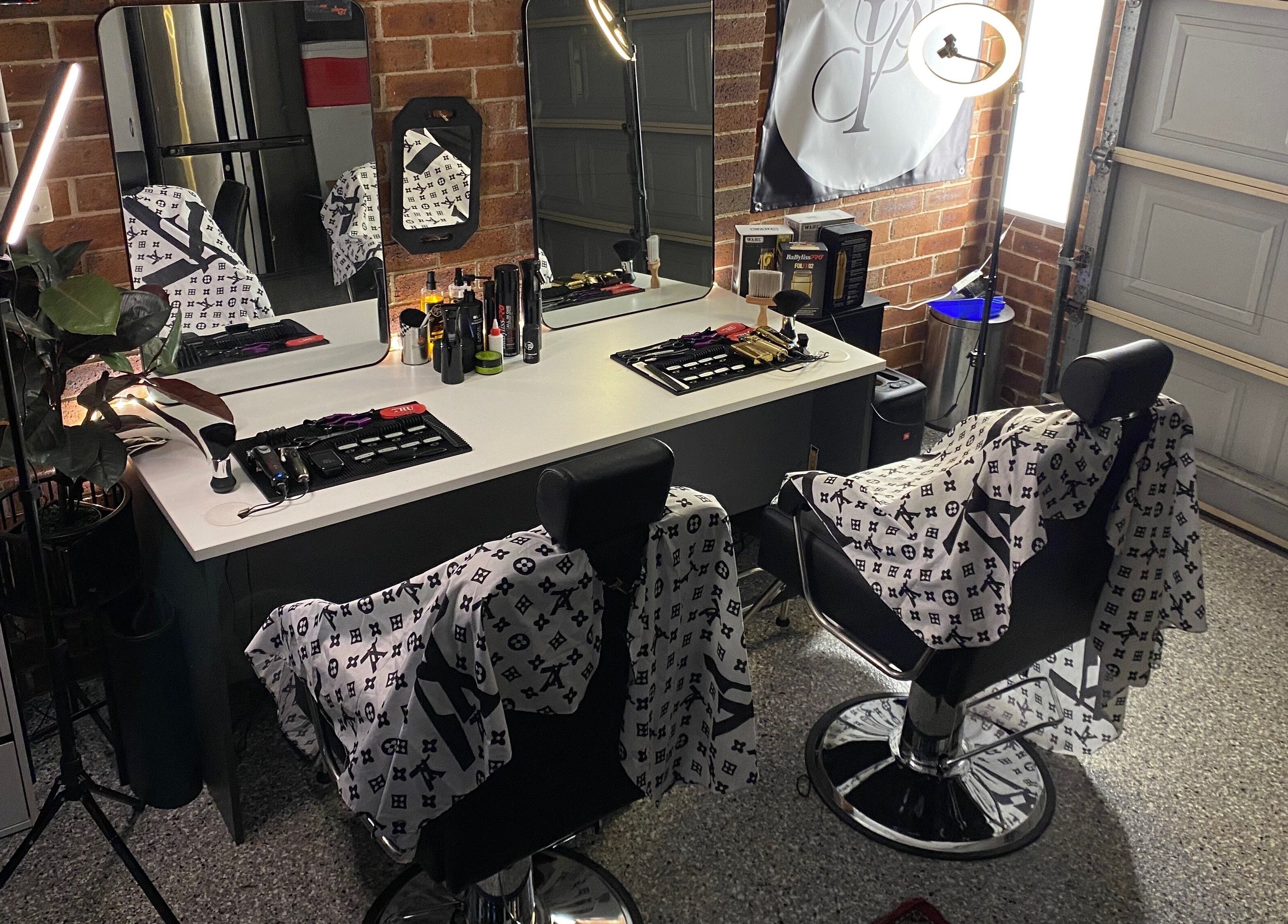 Elegant salon interior at Prasad Productions, Prestons, New South Wales, AU, showcasing modern barber chairs and mirrors.