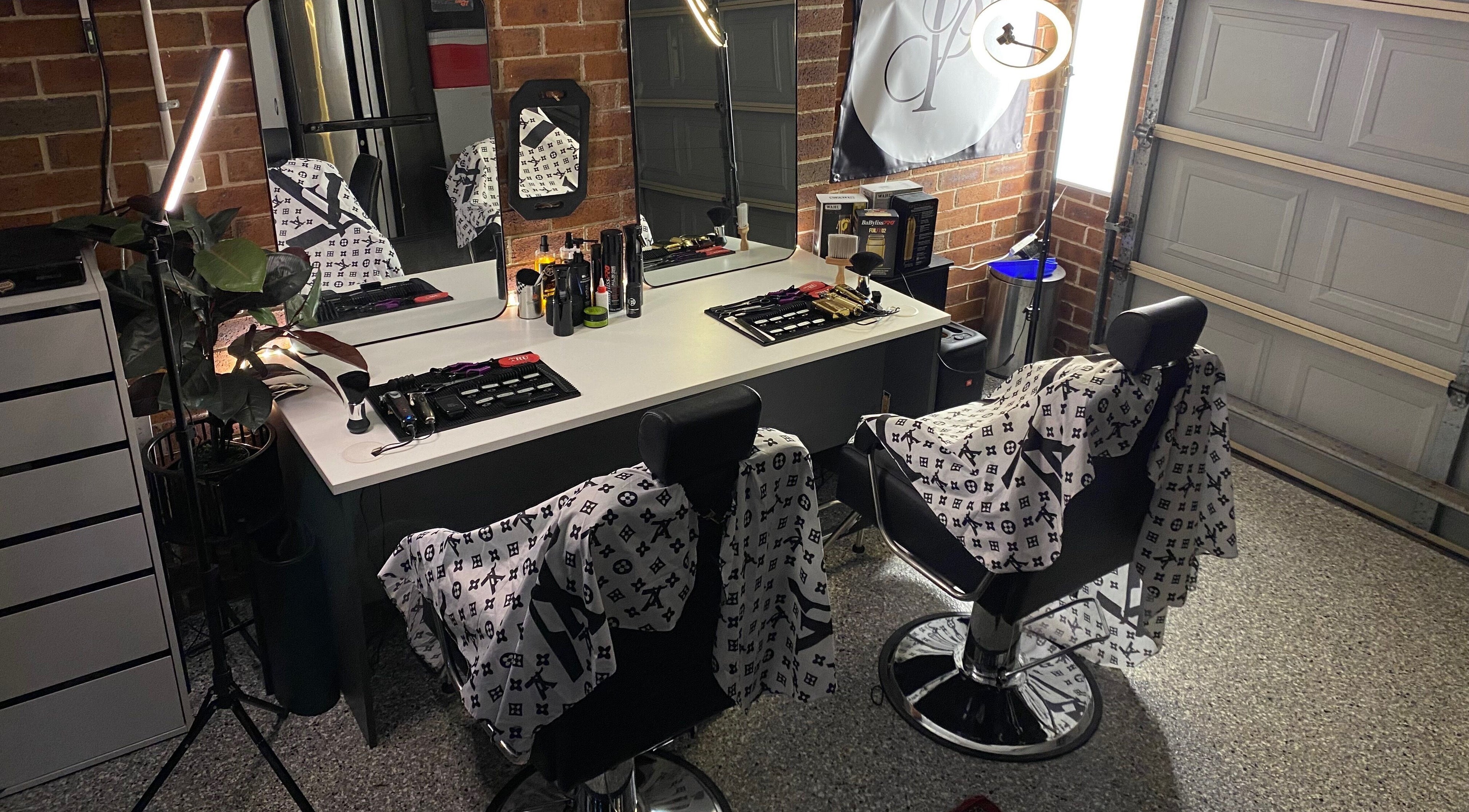 Elegant salon interior at Prasad Productions, Prestons, New South Wales, AU, showcasing modern barber chairs and mirrors.