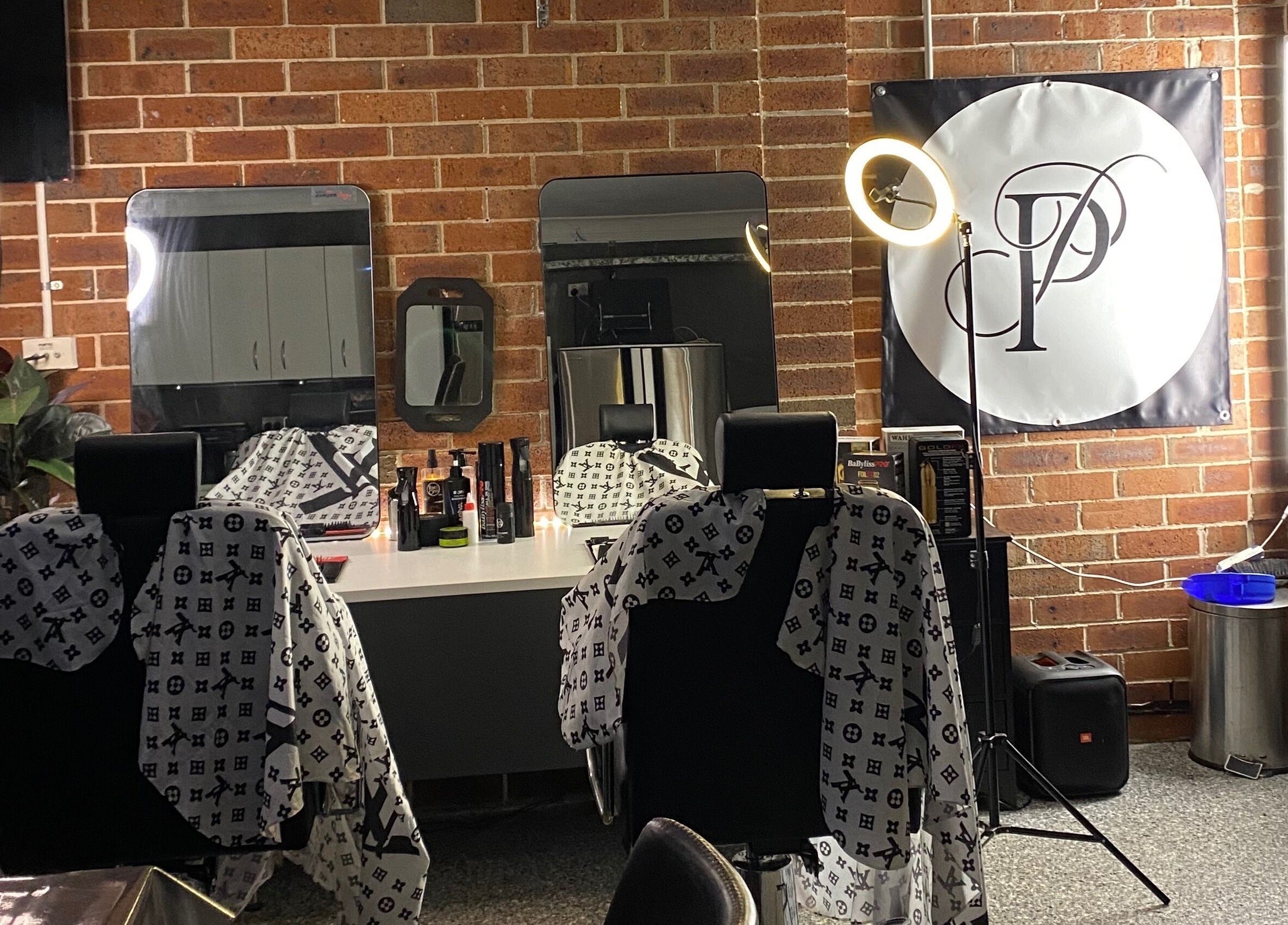 Chic salon interior at Prasad Productions, Prestons, New South Wales, AU featuring stylish barber chairs.