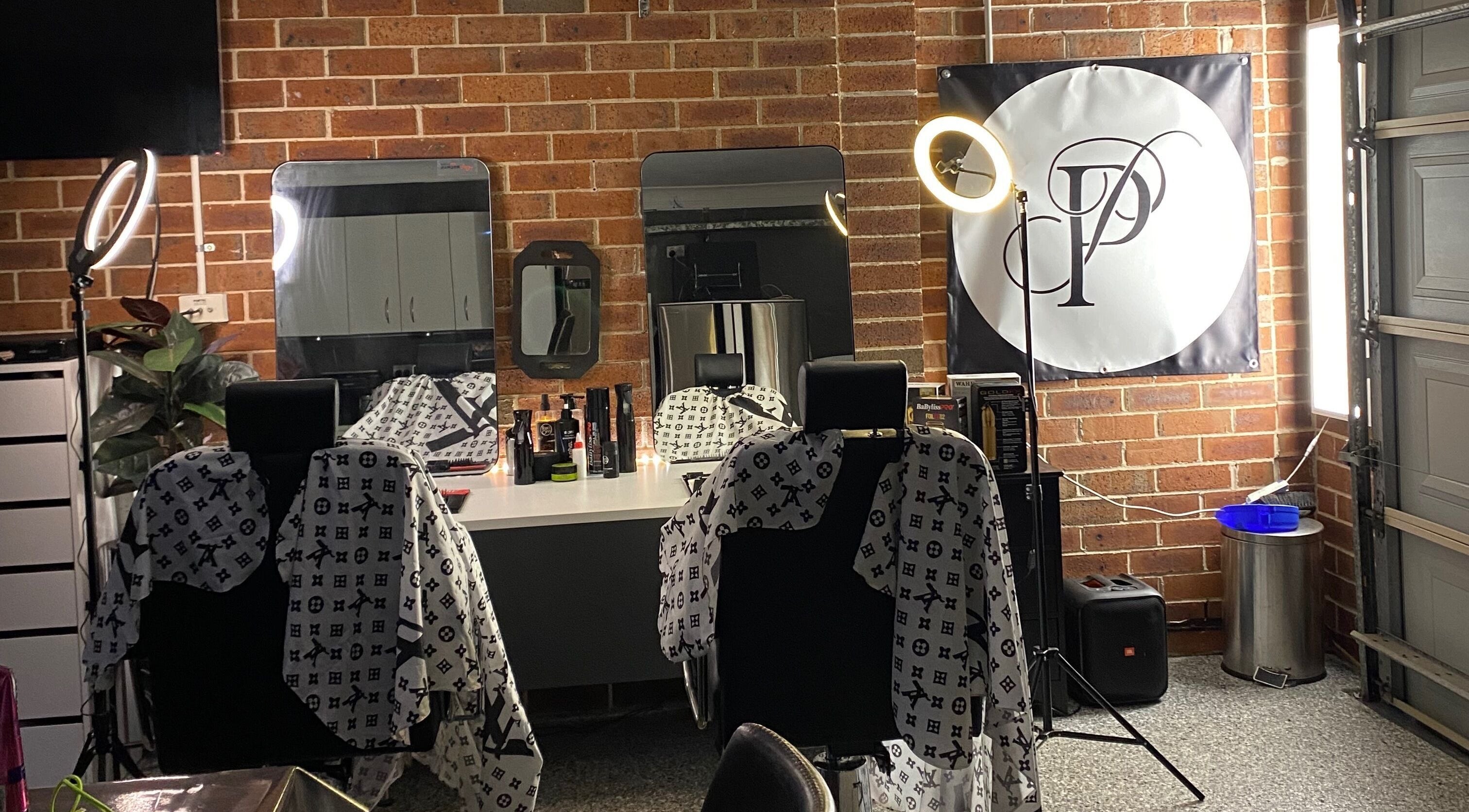 Chic salon interior at Prasad Productions, Prestons, New South Wales, AU featuring stylish barber chairs.