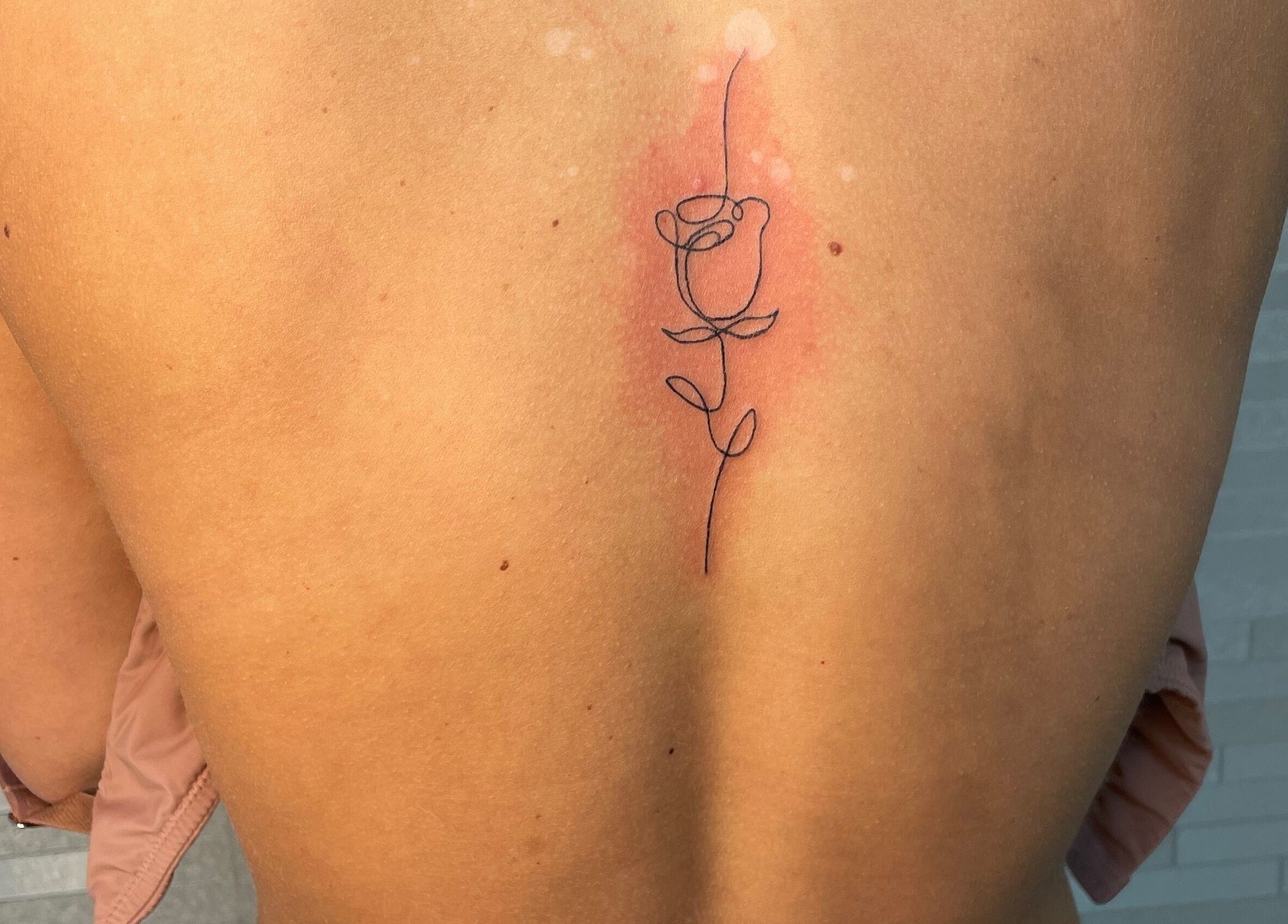 Delicate rose tattoo on back designed at Adara Ink, Chadderton, England, GB.