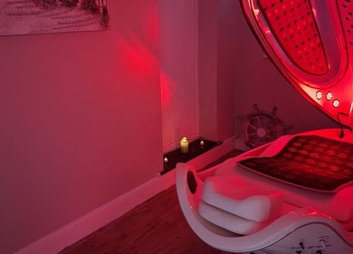 Relaxing red light therapy room at Silk Powder Limited in Leicestershire, GB, with modern spa equipment.