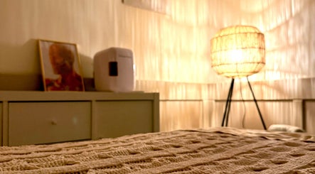 Cozy corner in Hygge Space Holistic Face Massage, Galway, features warm lighting and a textured blanket.