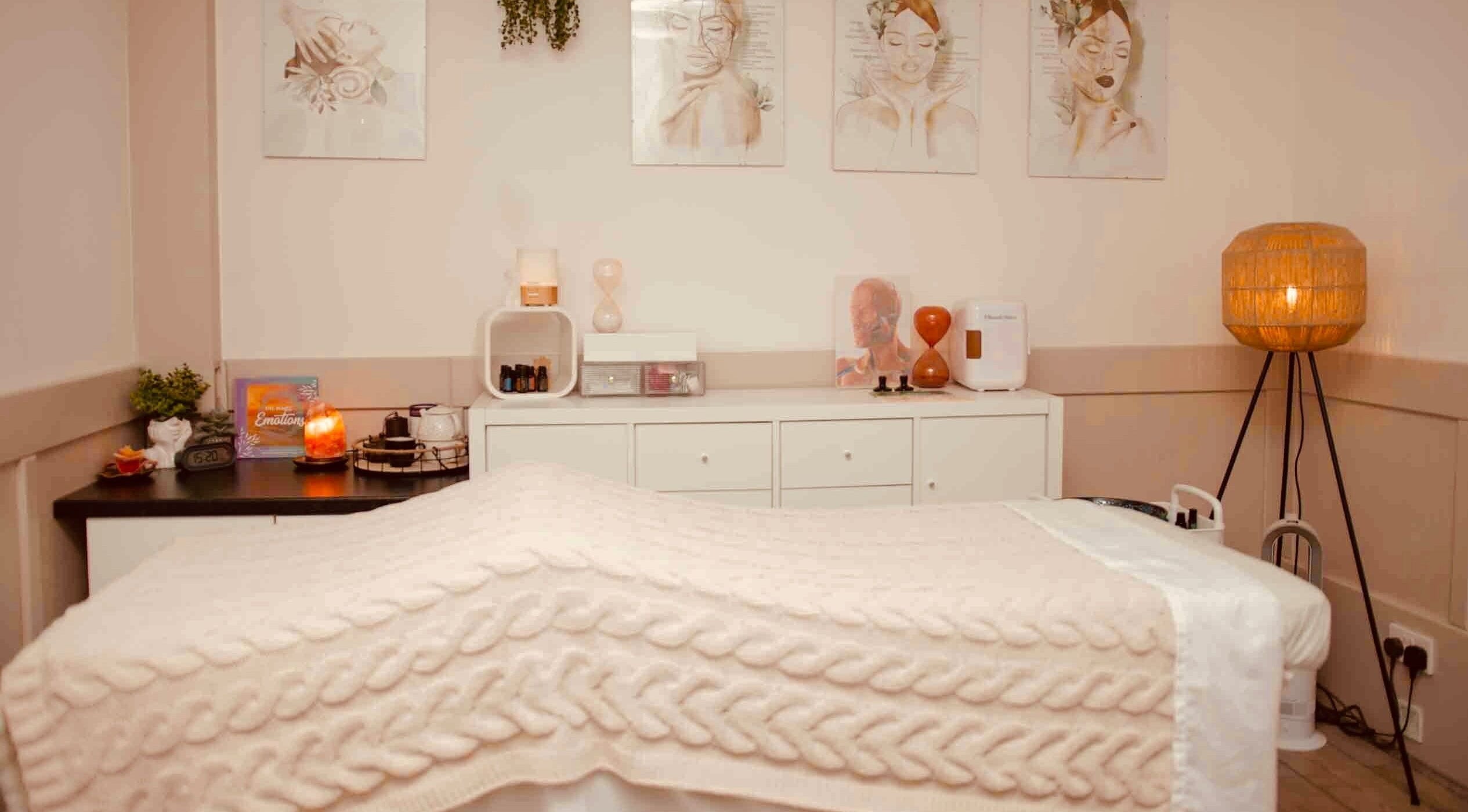 Cozy massage room at Hygge Space Holistic Face Massage, Galway, County Galway, IE with ambient lighting.