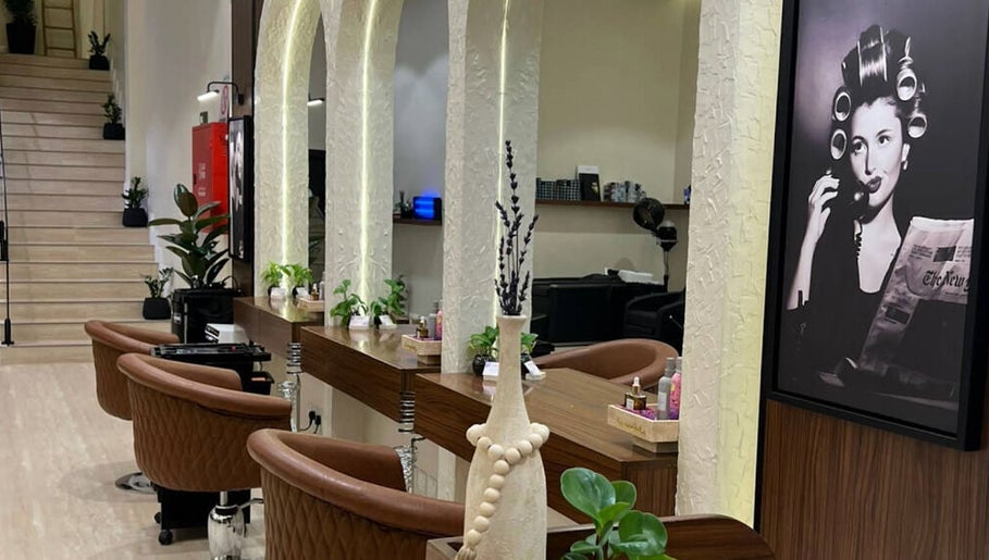 Lavandula Salon's elegant interior in Riyadh, Riyadh Province, SA features vintage decor and cozy styling chairs.