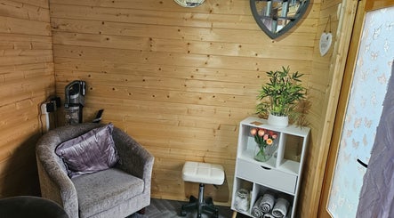 Inviting relaxation area at Shells Nailz in Chelmsford, England. Features plush chair, shelf, and decor.