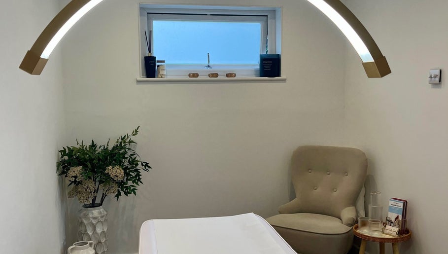 Relaxing treatment room at Brows & Beauty by Georgia, Effingham, England, GB with cozy chair and decor.