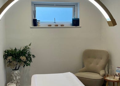 Relaxing treatment room at Brows & Beauty by Georgia in Effingham, England, GB with cozy chair and calming decor.