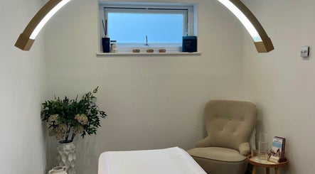 Relaxing treatment room at Brows & Beauty by Georgia in Effingham, England, GB with cozy chair and calming decor.