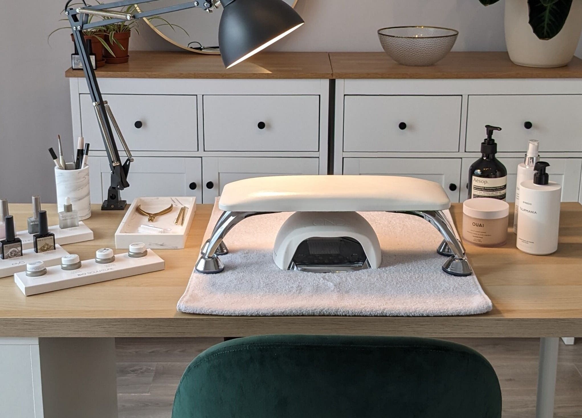 Elegant nail care setup at Click Nails, Cheltenham, England, GB, showcasing polish bottles and tools.