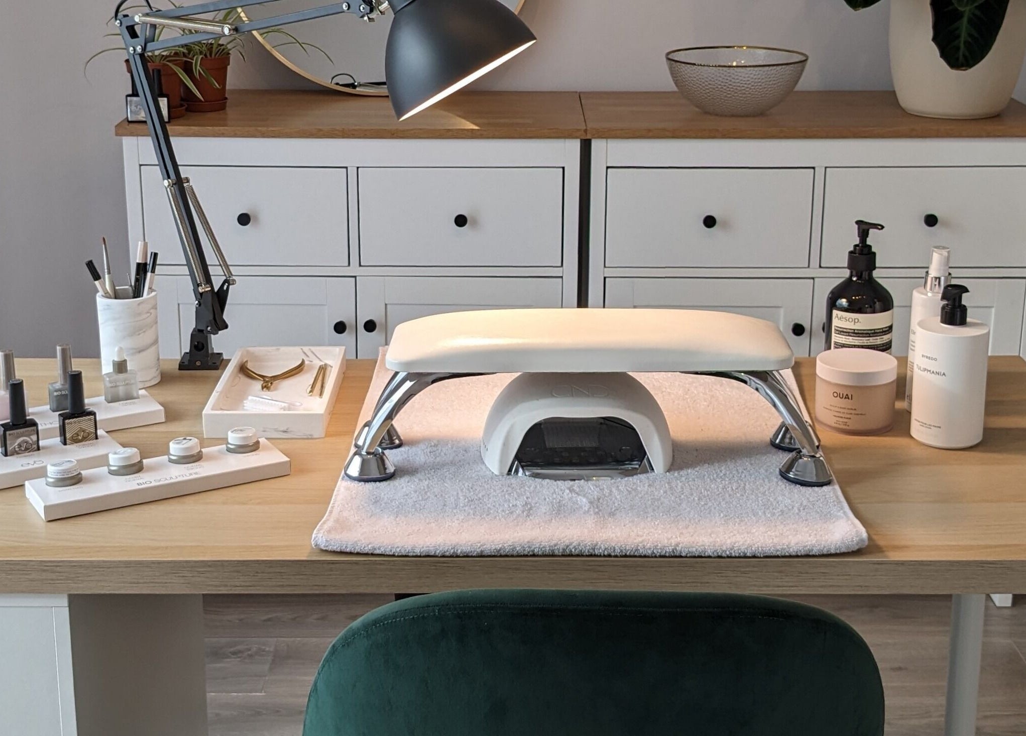 Elegant nail care setup at Click Nails, Cheltenham, England, GB, showcasing polish bottles and tools.