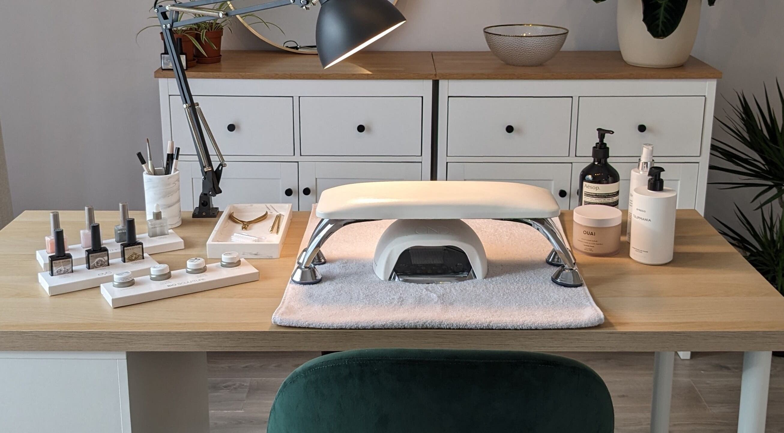 Elegant nail care setup at Click Nails, Cheltenham, England, GB, showcasing polish bottles and tools.