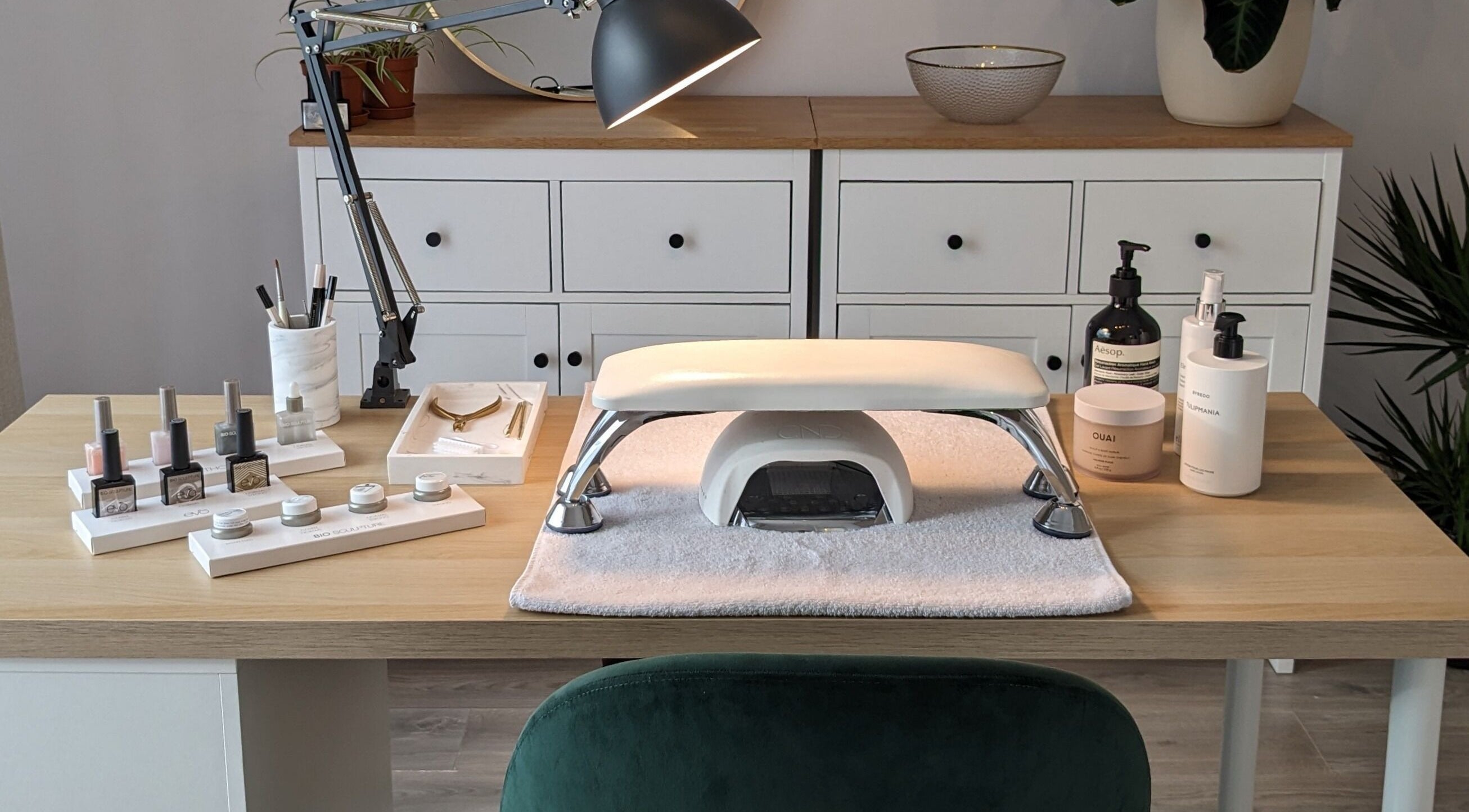 Elegant nail care setup at Click Nails, Cheltenham, England, GB, showcasing polish bottles and tools.