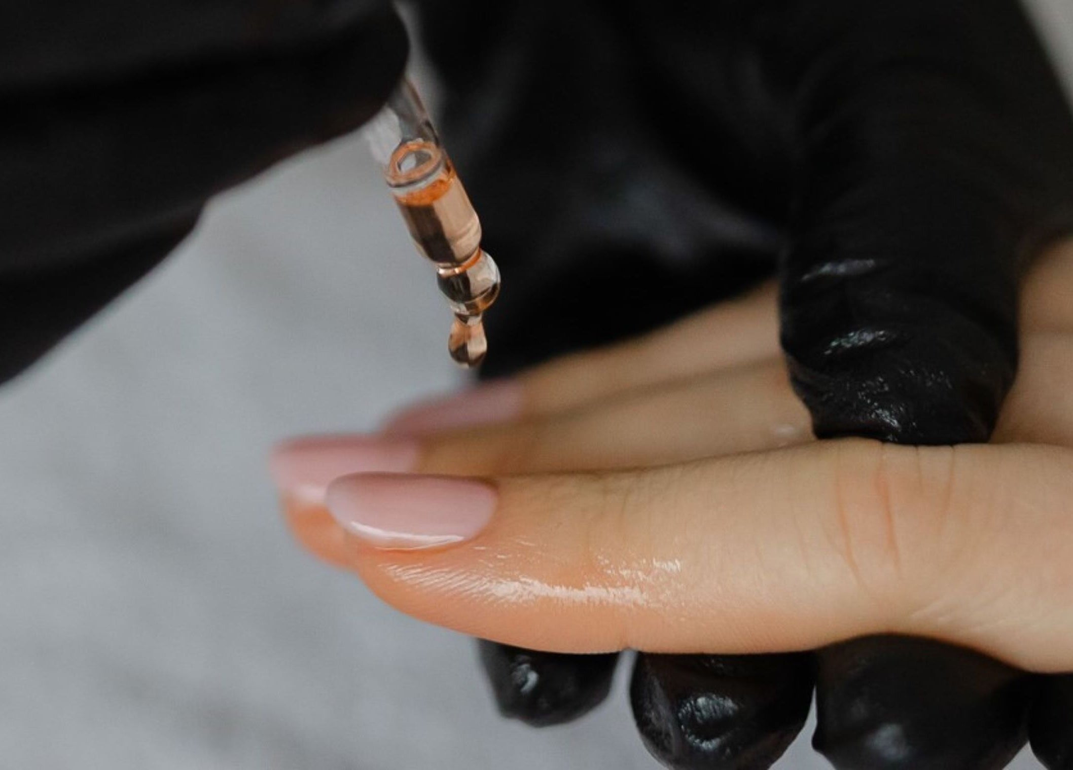 Nail oil application at Click Nails, Cheltenham, England, GB, showcasing expert care for healthy hands.