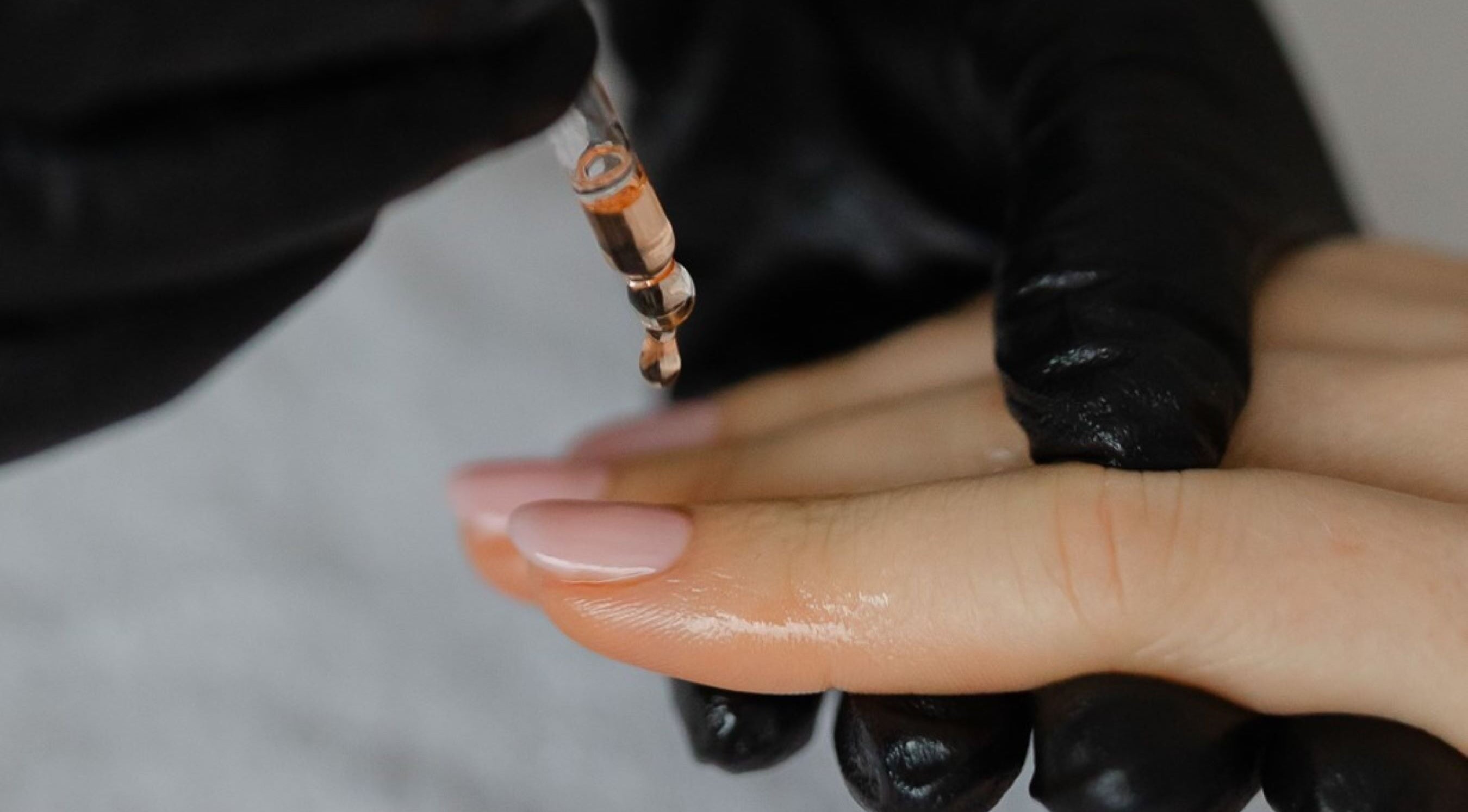 Nail oil application at Click Nails, Cheltenham, England, GB, showcasing expert care for healthy hands.