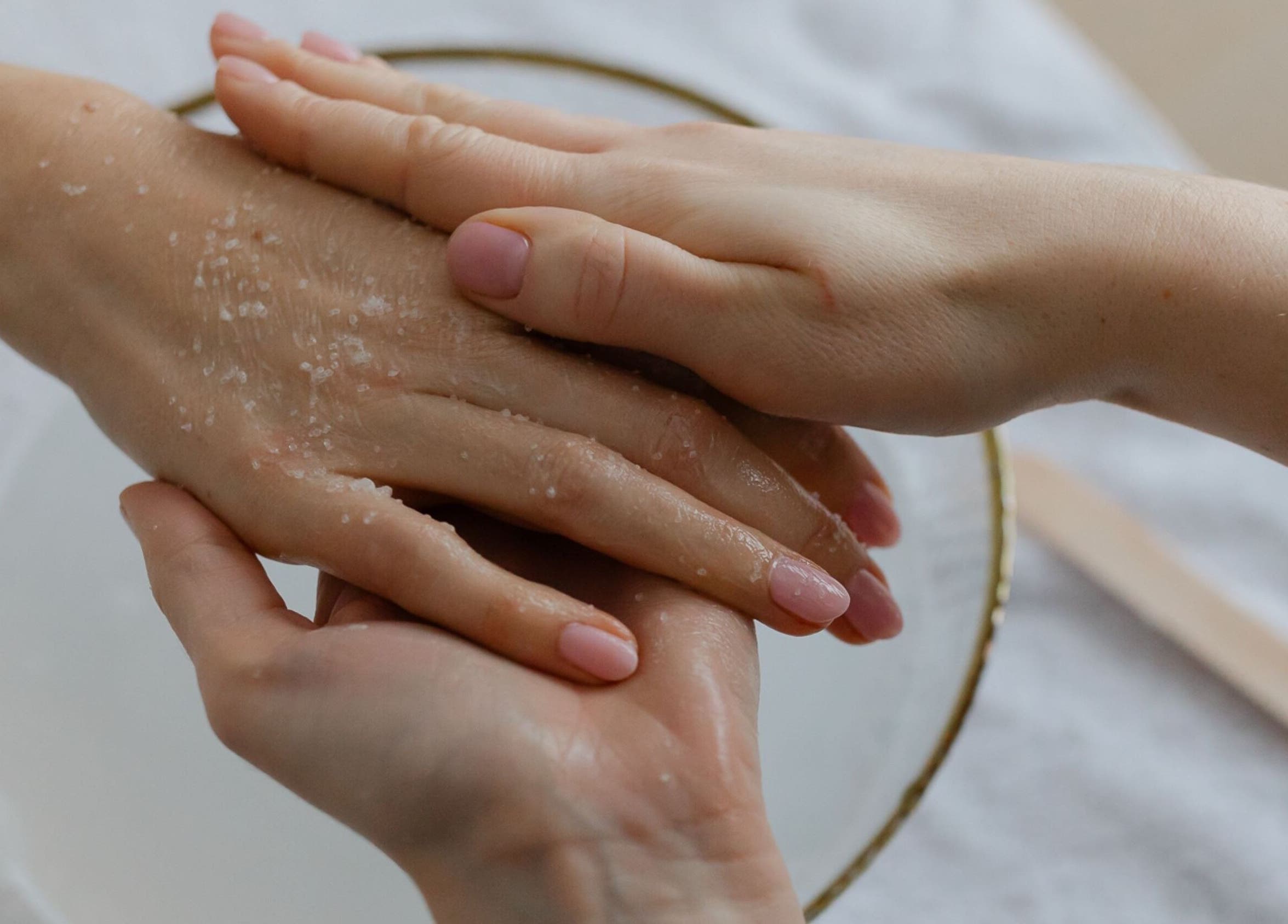 Hand exfoliation treatment at Click Nails, Cheltenham, England, GB. Pampered hands with gentle care.