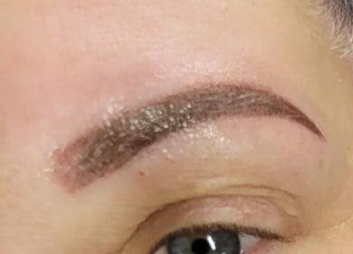 Close-up of expertly shaped eyebrow at Cupids Glow, Bolton, England, GB. Flawless eyebrow enhancement.