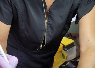 A skilled professional at Cupids Glow, Bolton, England, GB, preparing for a beauty treatment.