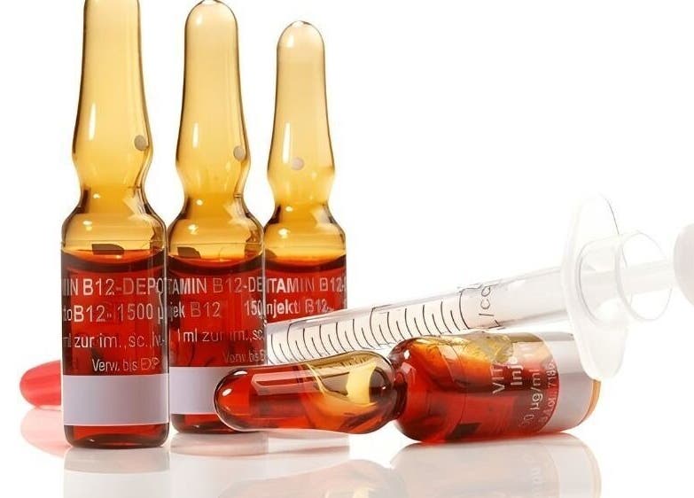 Vitamin B12 ampoules and syringe at Cupids Glow, Bolton, England, GB, highlighting wellness services.