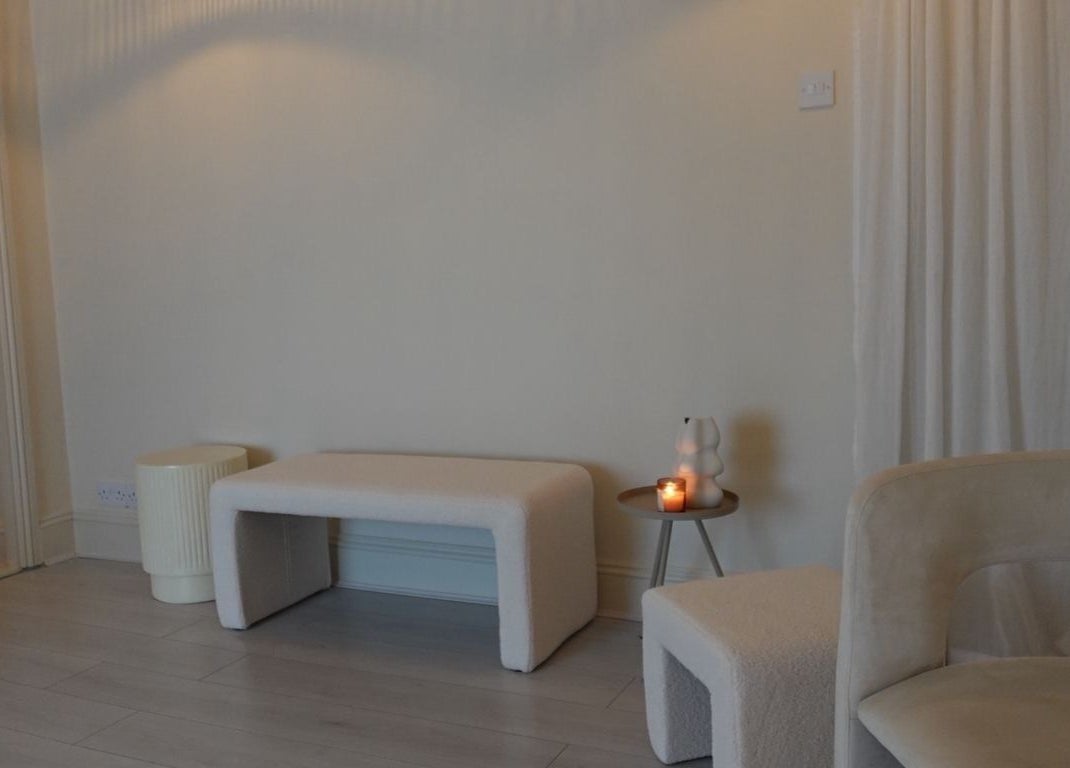 Cozy waiting area at Reflexology with Gemma in Nottingham, England, GB with soft lighting and minimalist decor.