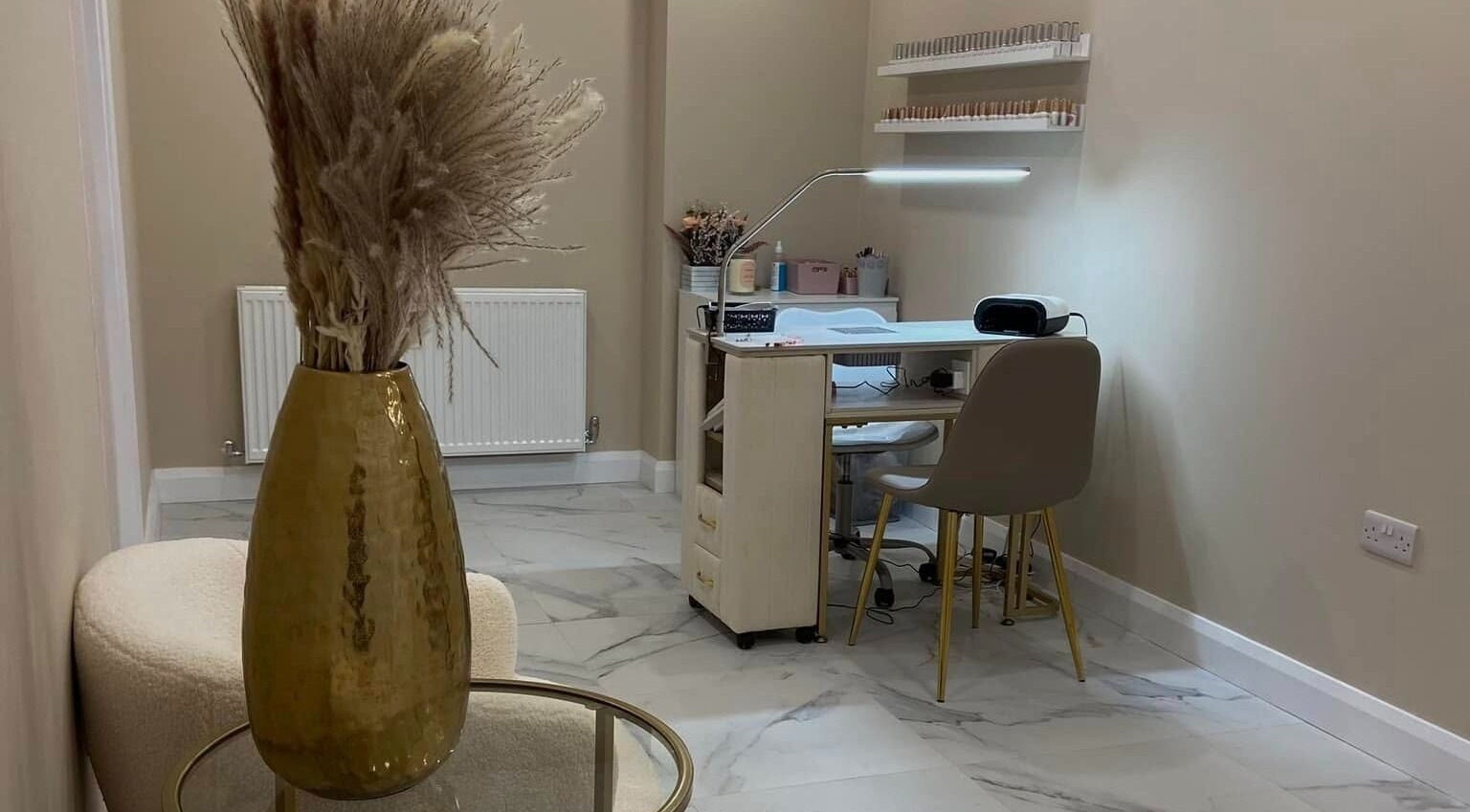 Cozy beauty station at Studio 3, Swatragh, Northern Ireland, GB with a vase of pampas grass on display.