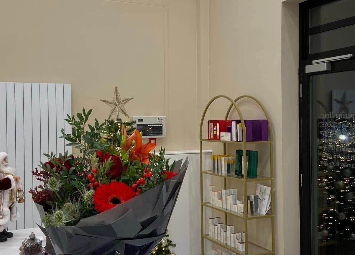 Studio 3 in Swatragh, Northern Ireland with holiday decor, floral bouquet, and product shelves.