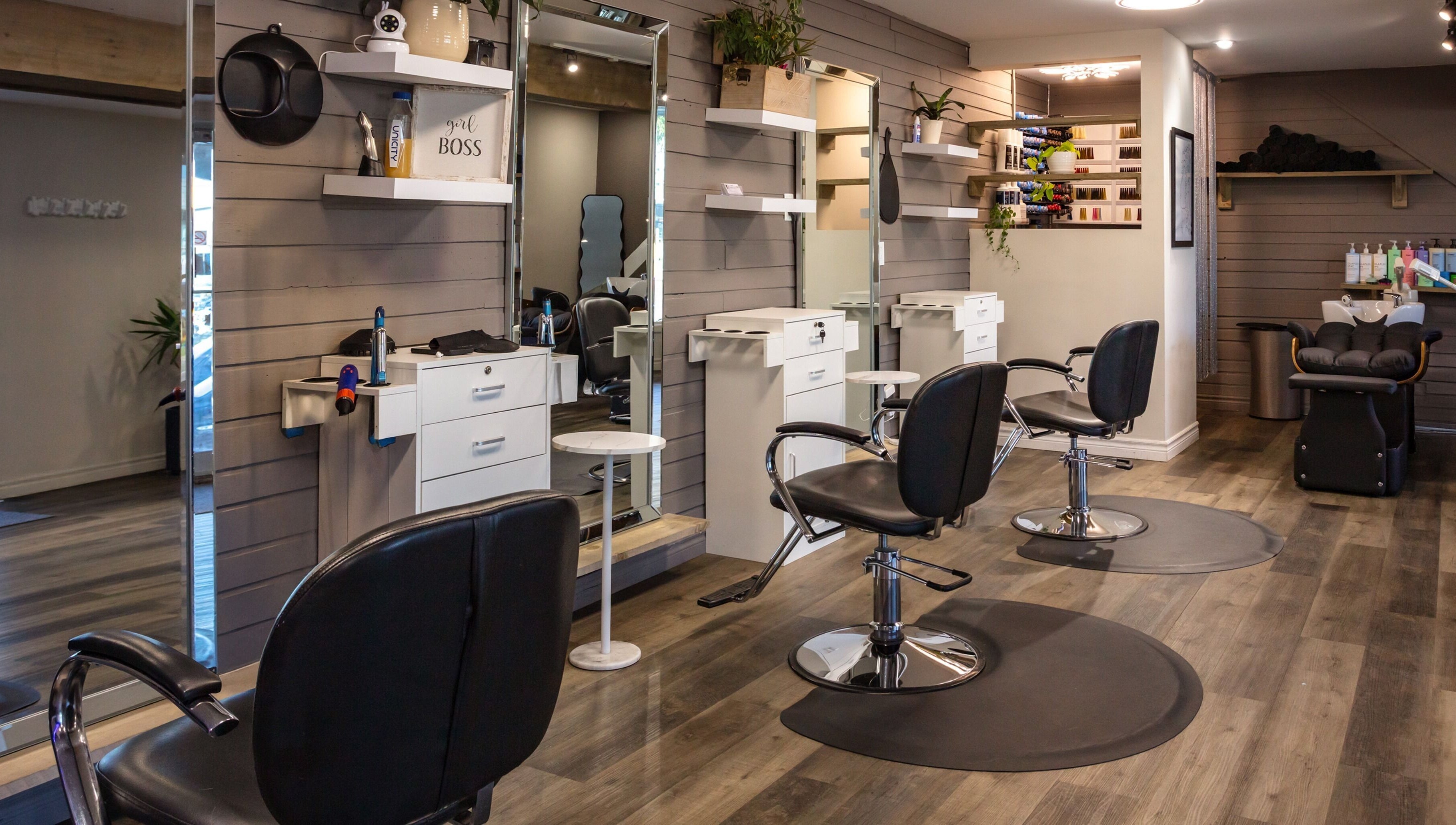 Interior of Mirror Mirror Hair Studio in Oshawa, Ontario, CA, featuring modern salon chairs and sleek design.