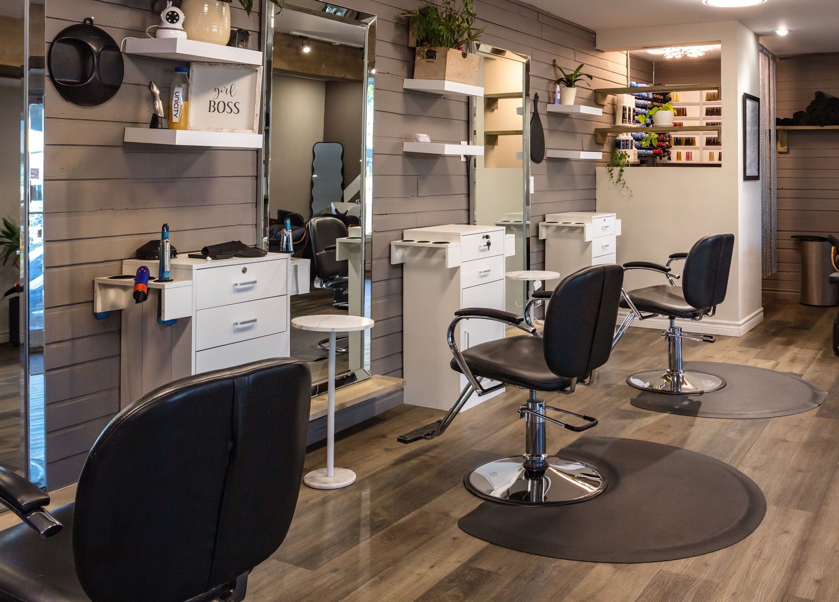 Interior of Mirror Mirror Hair Studio in Oshawa, Ontario, CA, featuring modern salon chairs and sleek design.
