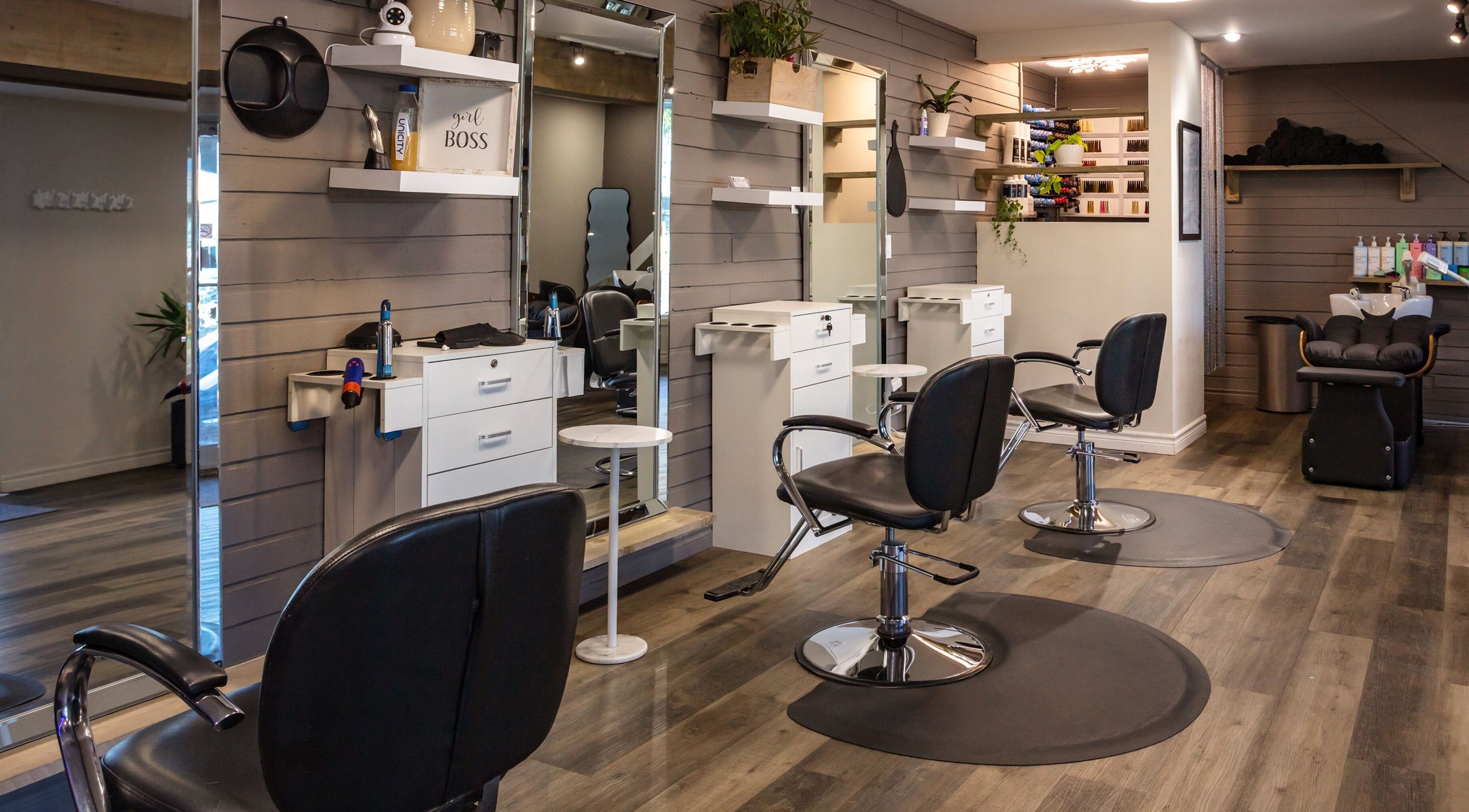 Interior of Mirror Mirror Hair Studio in Oshawa, Ontario, CA, featuring modern salon chairs and sleek design.