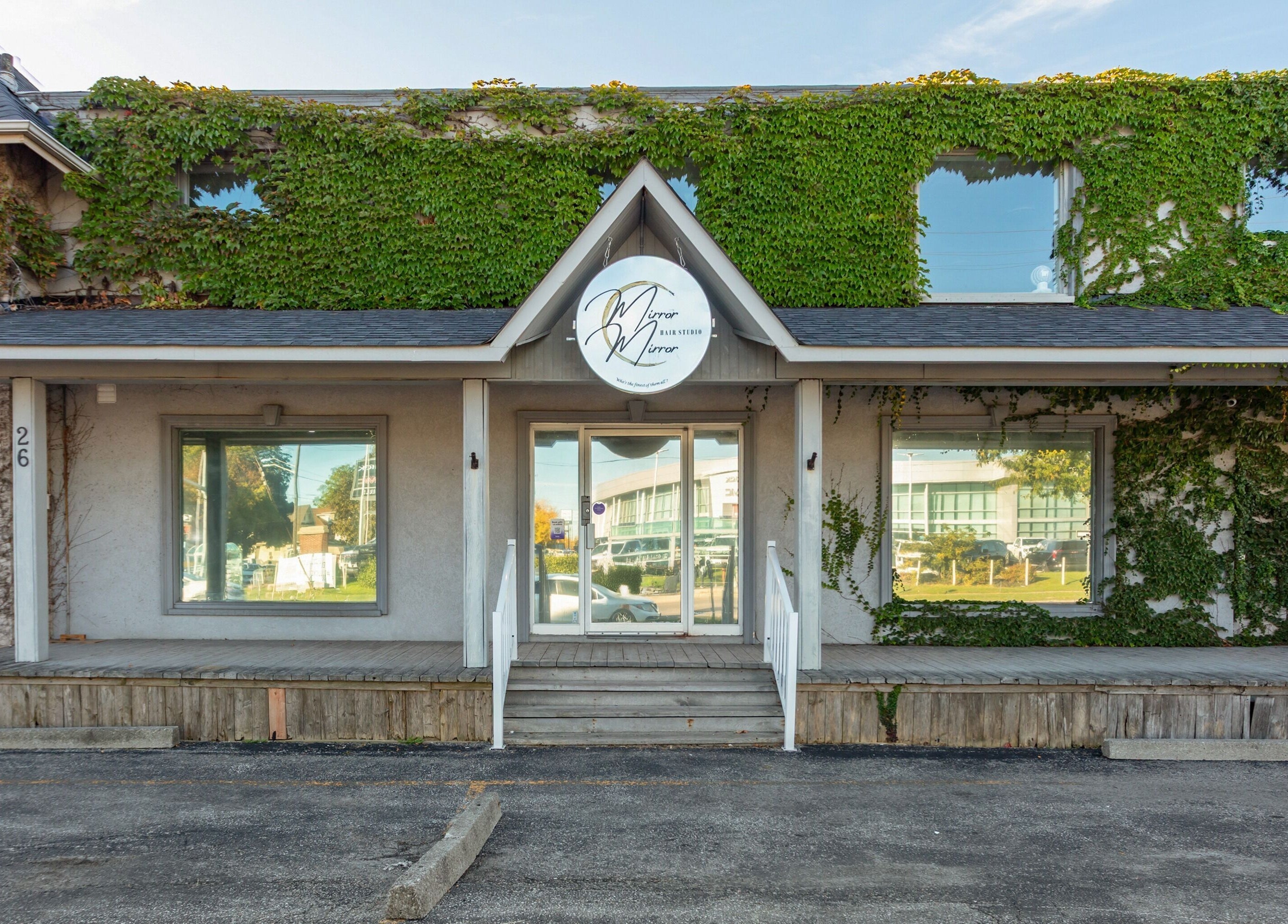 Entrance of Mirror Mirror Hair Studio in Oshawa, Ontario, CA, covered in lush green ivy.