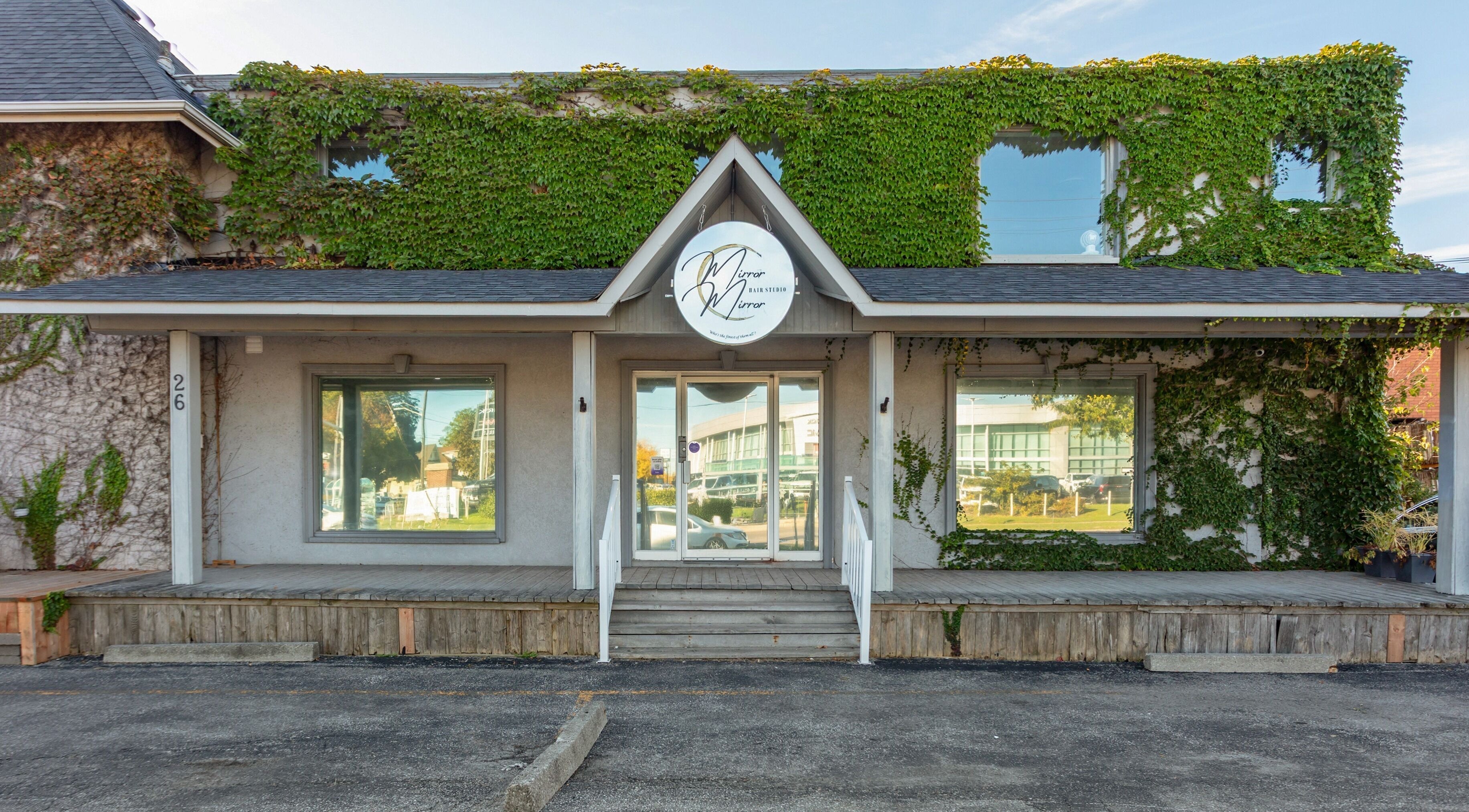 Entrance of Mirror Mirror Hair Studio in Oshawa, Ontario, CA, covered in lush green ivy.