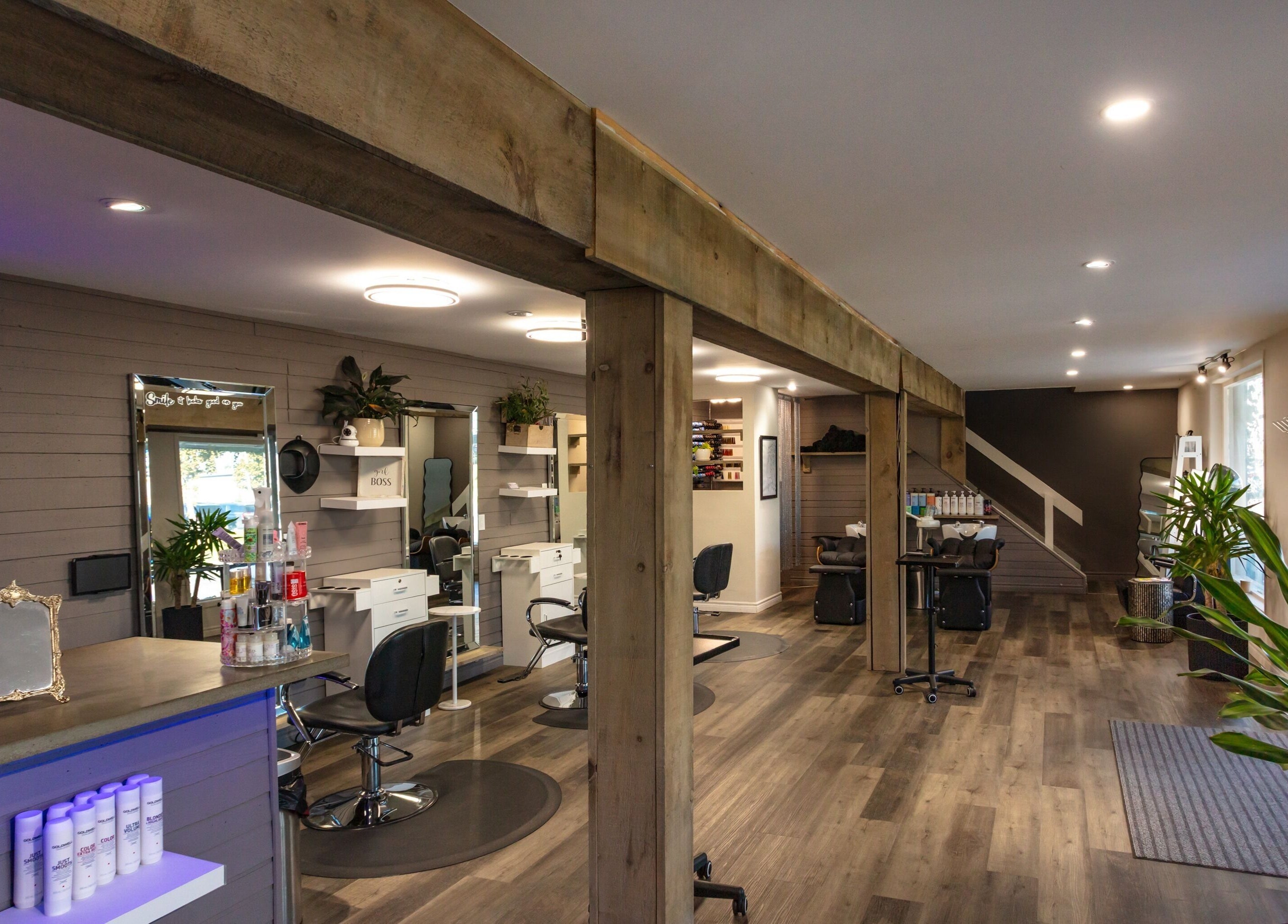 Interior of Mirror Mirror Hair Studio, Oshawa, Ontario, CA, showcasing modern salon chairs and decor.