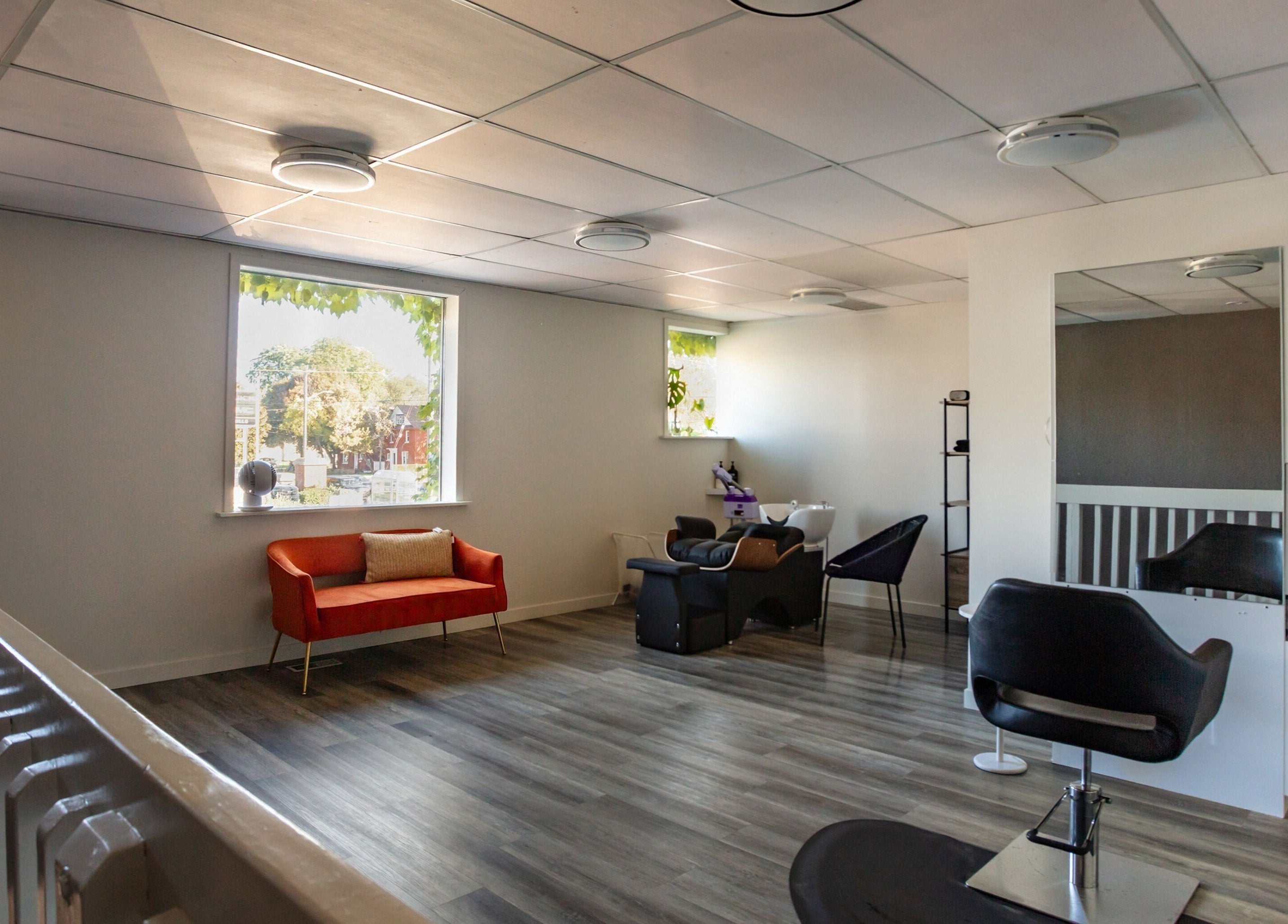 Modern interior of Mirror Mirror Hair Studio Oshawa, Ontario, CA with stylish seating and hair stations.